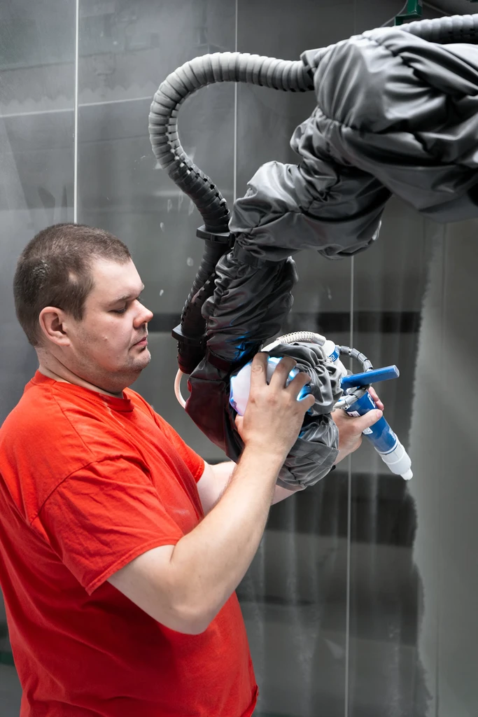 Paint shop worker setting up robotic trajectory
