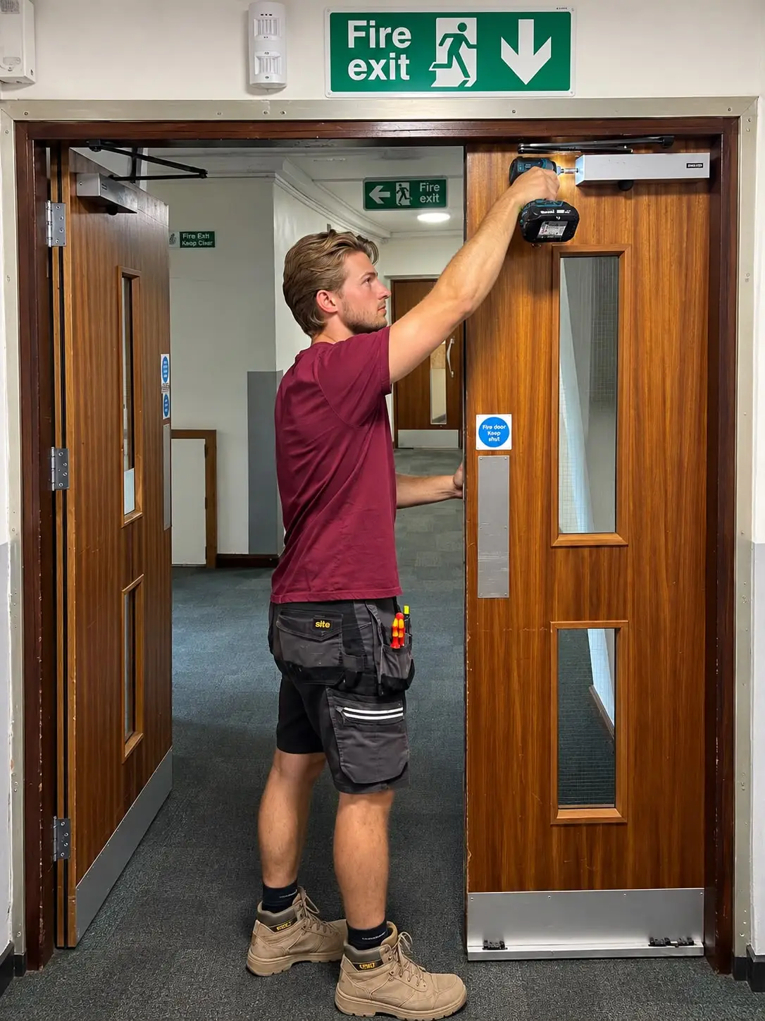 Technician repairing an industrial fire door