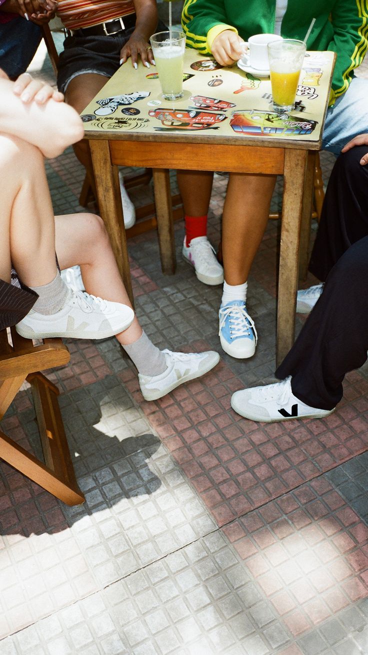 two people sitting at a table with laptops