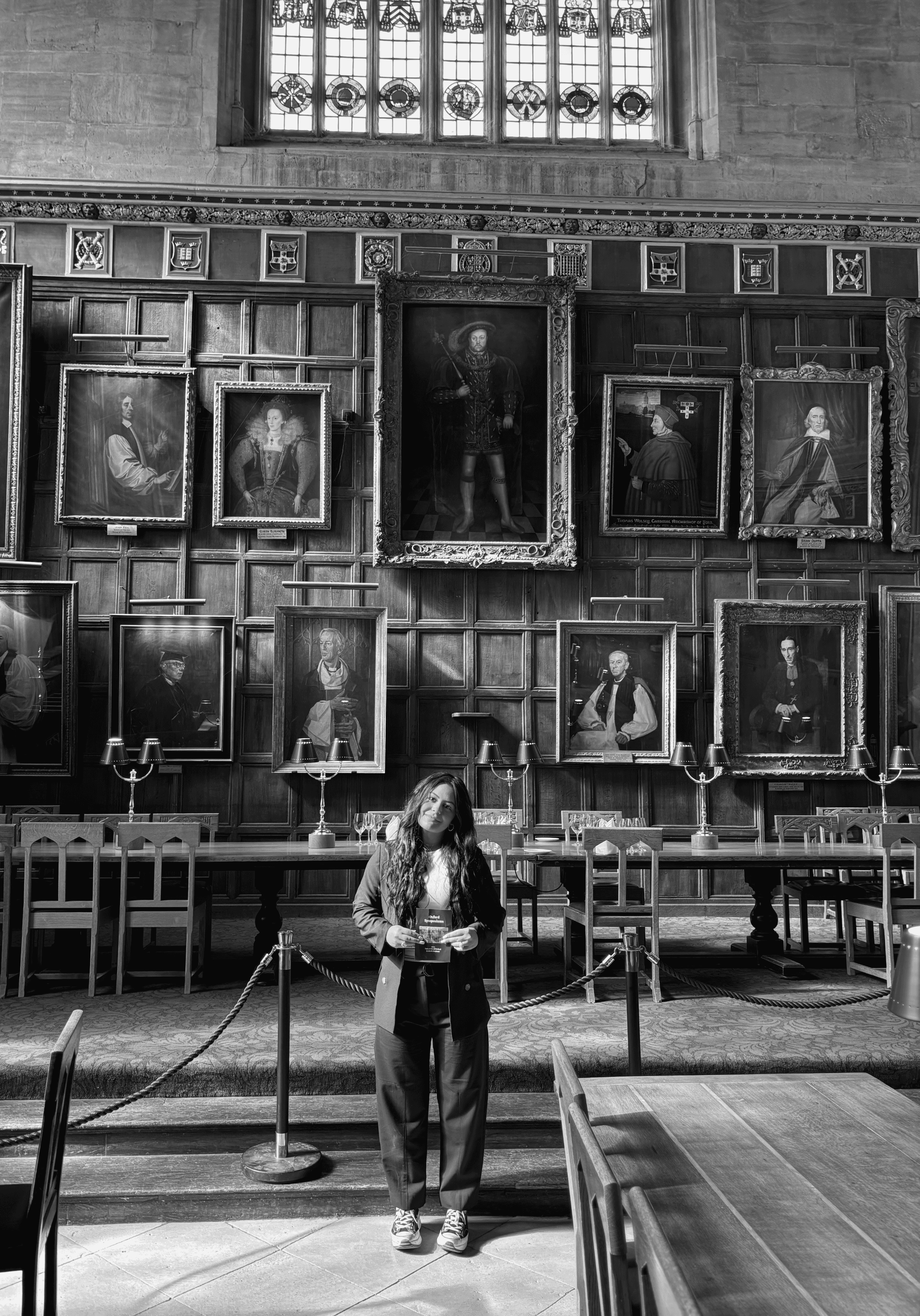 A man with glasses and a brown shirt, crossing his arms.