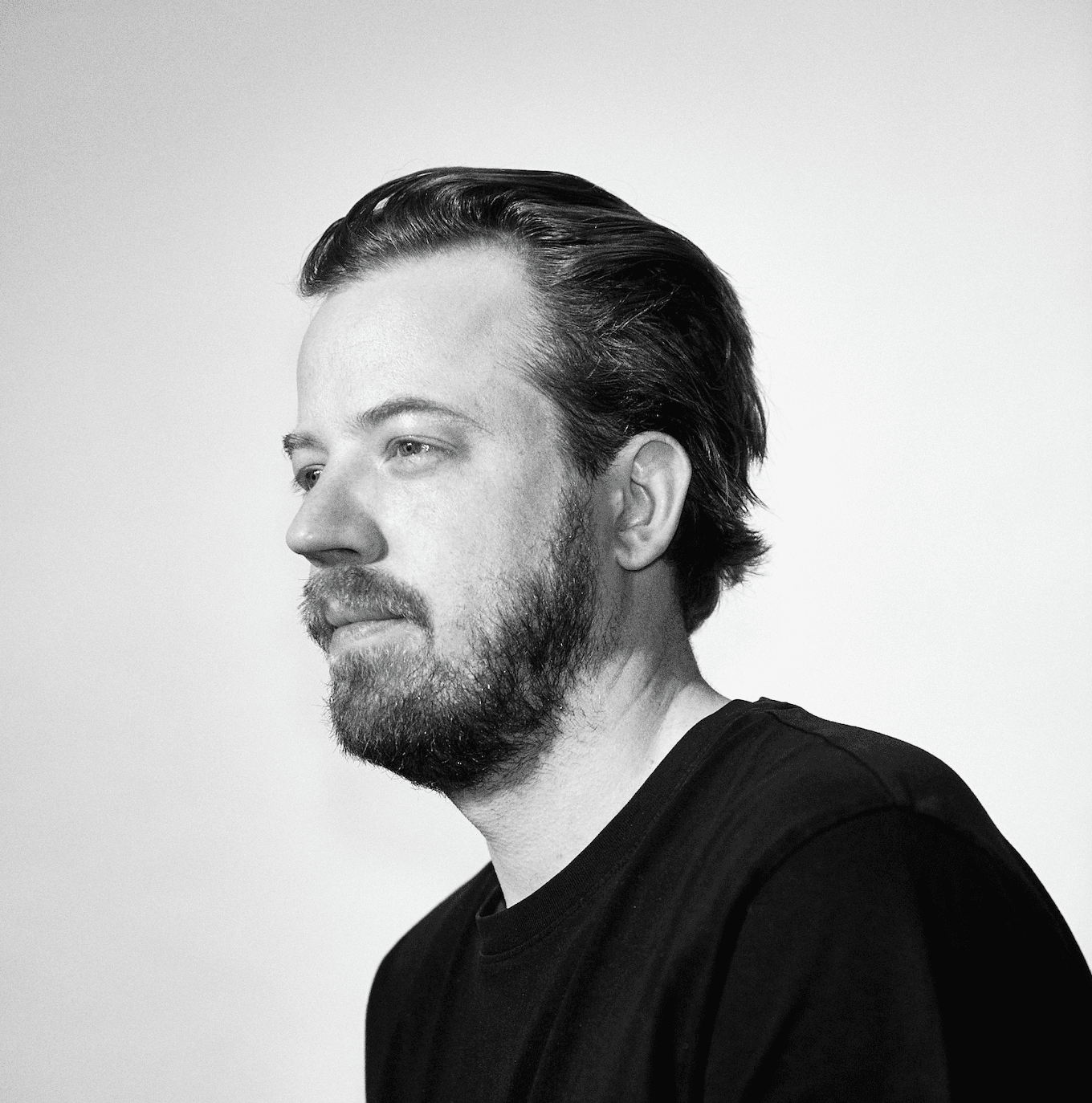 A smiling woman writing on a piece of paper in her home