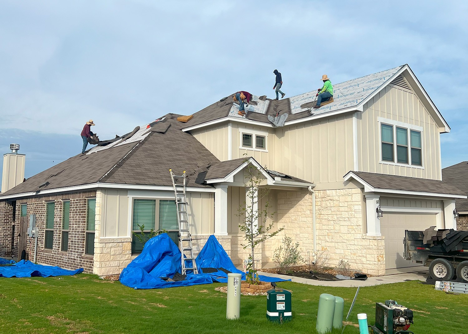 Atlas Roofing Pros in action during roof replacement