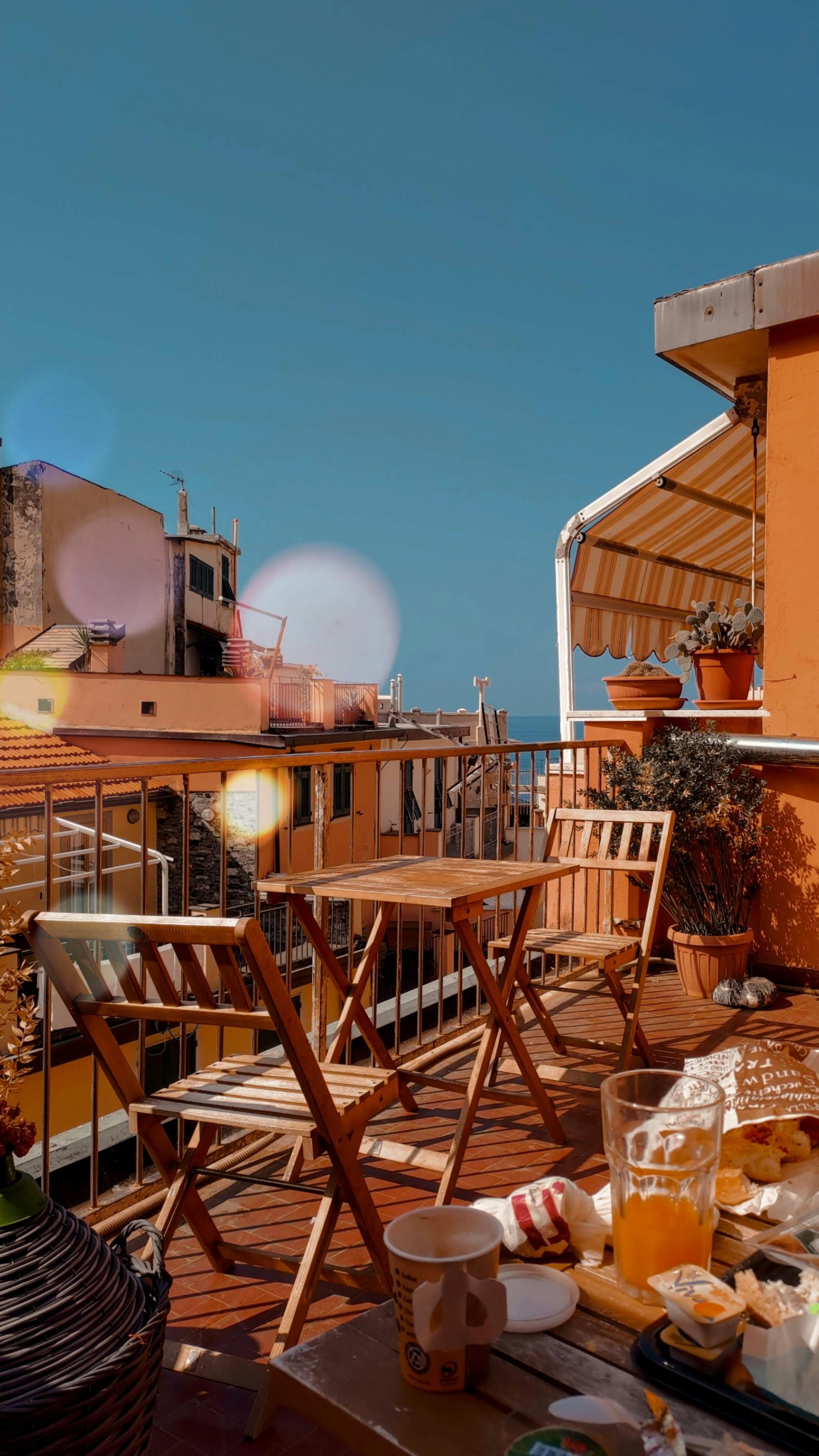 a balcony with a table and chairs on it