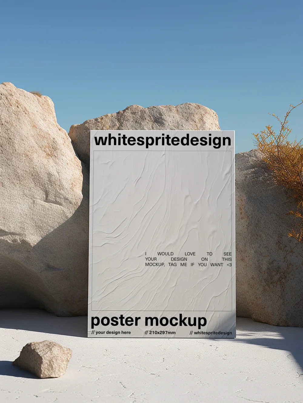 A minimalist A4 poster mockup set against a desert-like landscape with large beige rocks and sparse dry vegetation. The textured poster stands upright under natural daylight and a clear blue sky, creating a serene aesthetic.