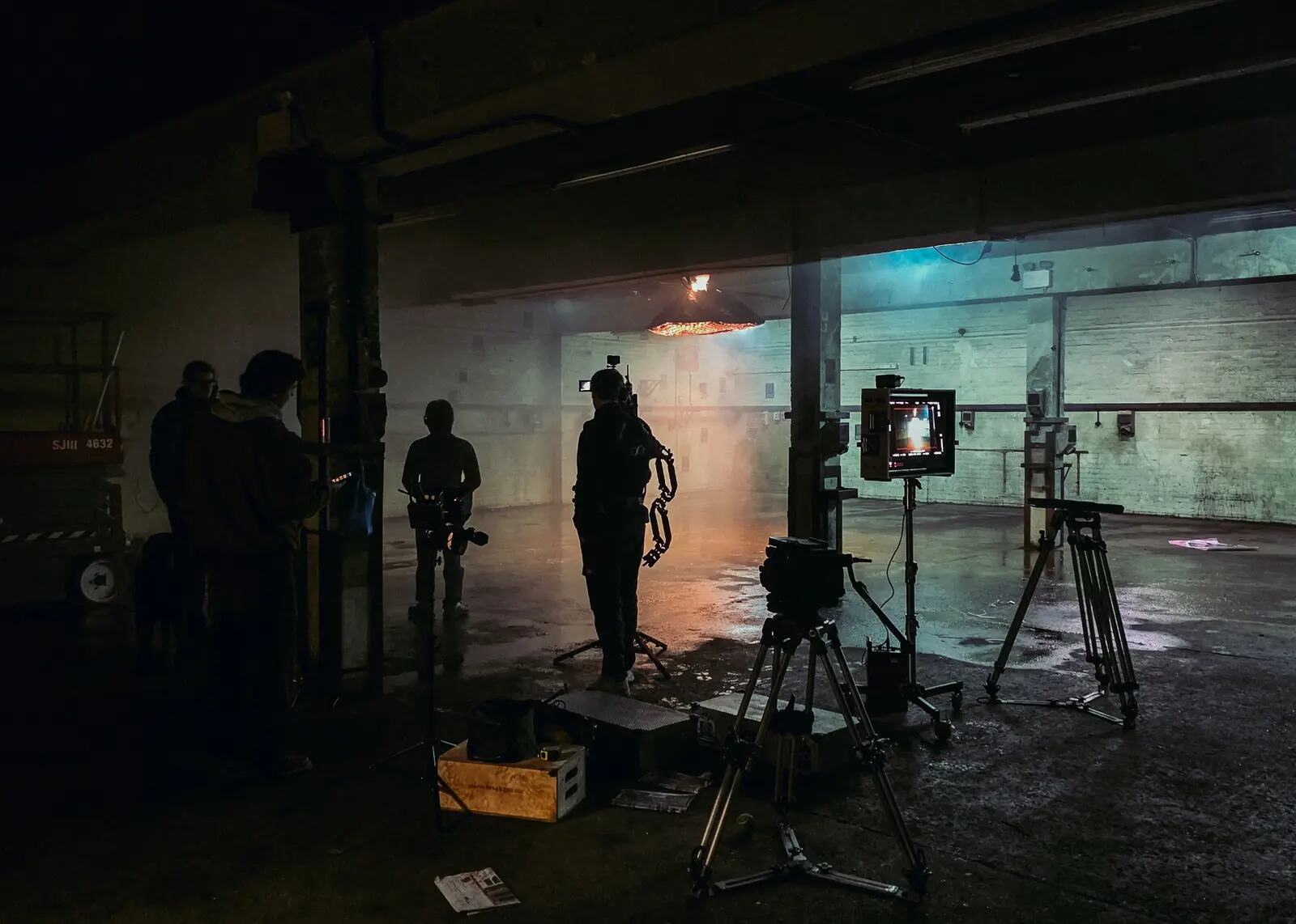 Camera operator and performers working on an industrial music video set