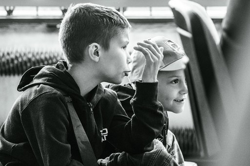 Młoda kobieta podnosi ciężar, trzymając sztangę przed ramionami. Zawody w podnoszeniu ciężarów U23.