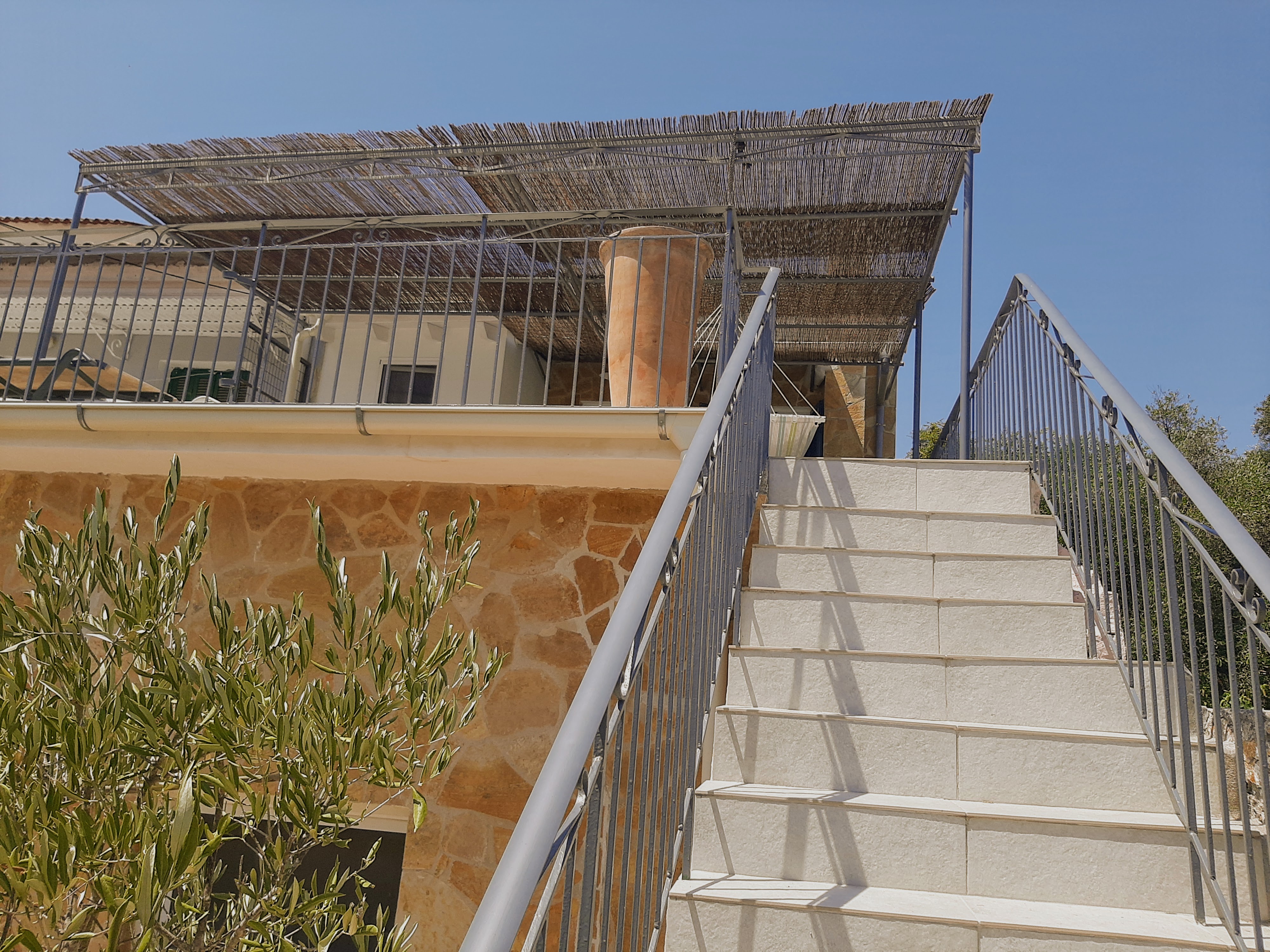 Entrance area and exterior façade of Villa Aspros with traditional stone architecture