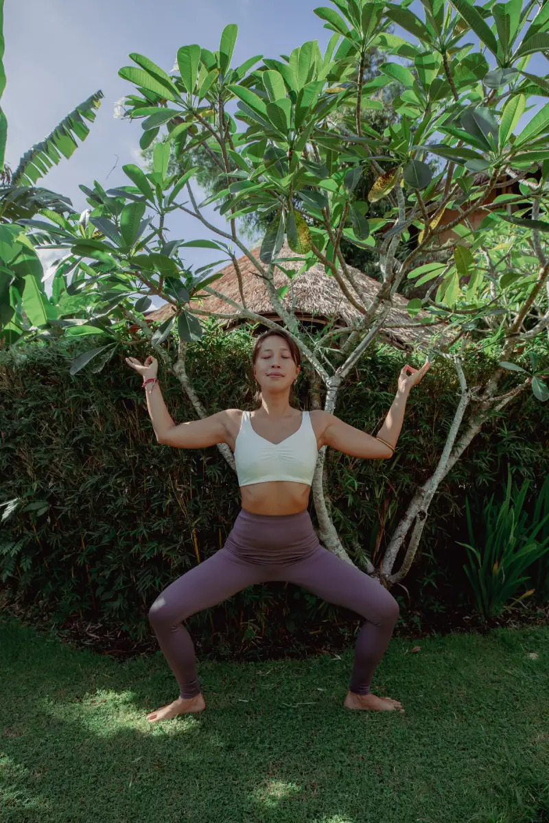 Advanced practitioner finding stillness in Goddess Pose Utkata Konasana for 300hr online YTT