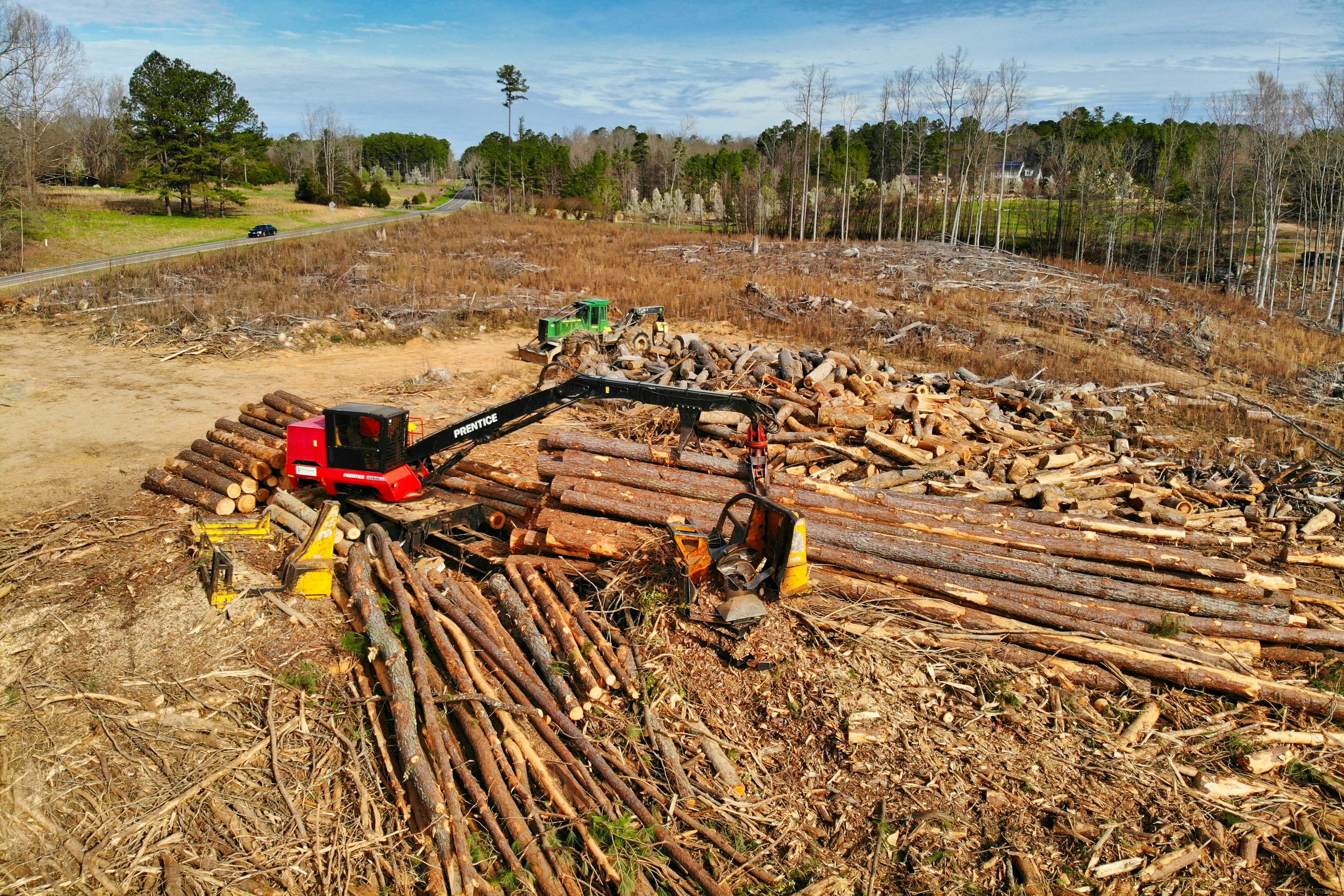 red and black heavy equipment on brown soil