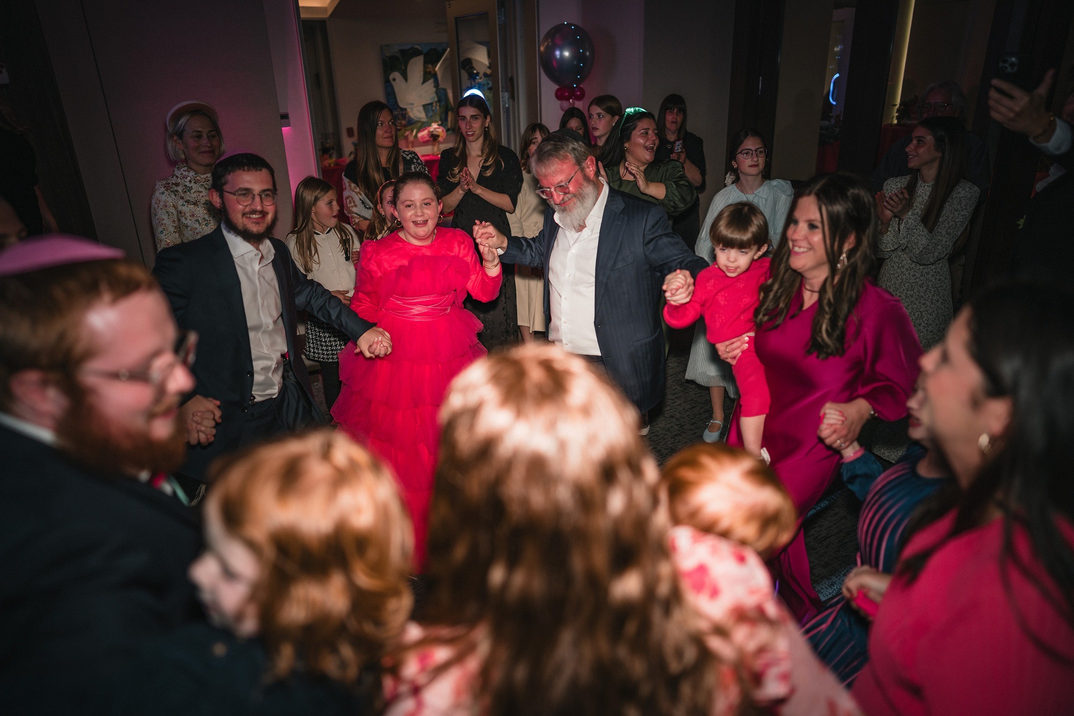 Family and guests celebrating together at a bat mitzvah party
