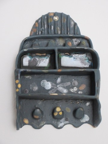 Dark ceramic wall shelf with gold speckled detail and compartments