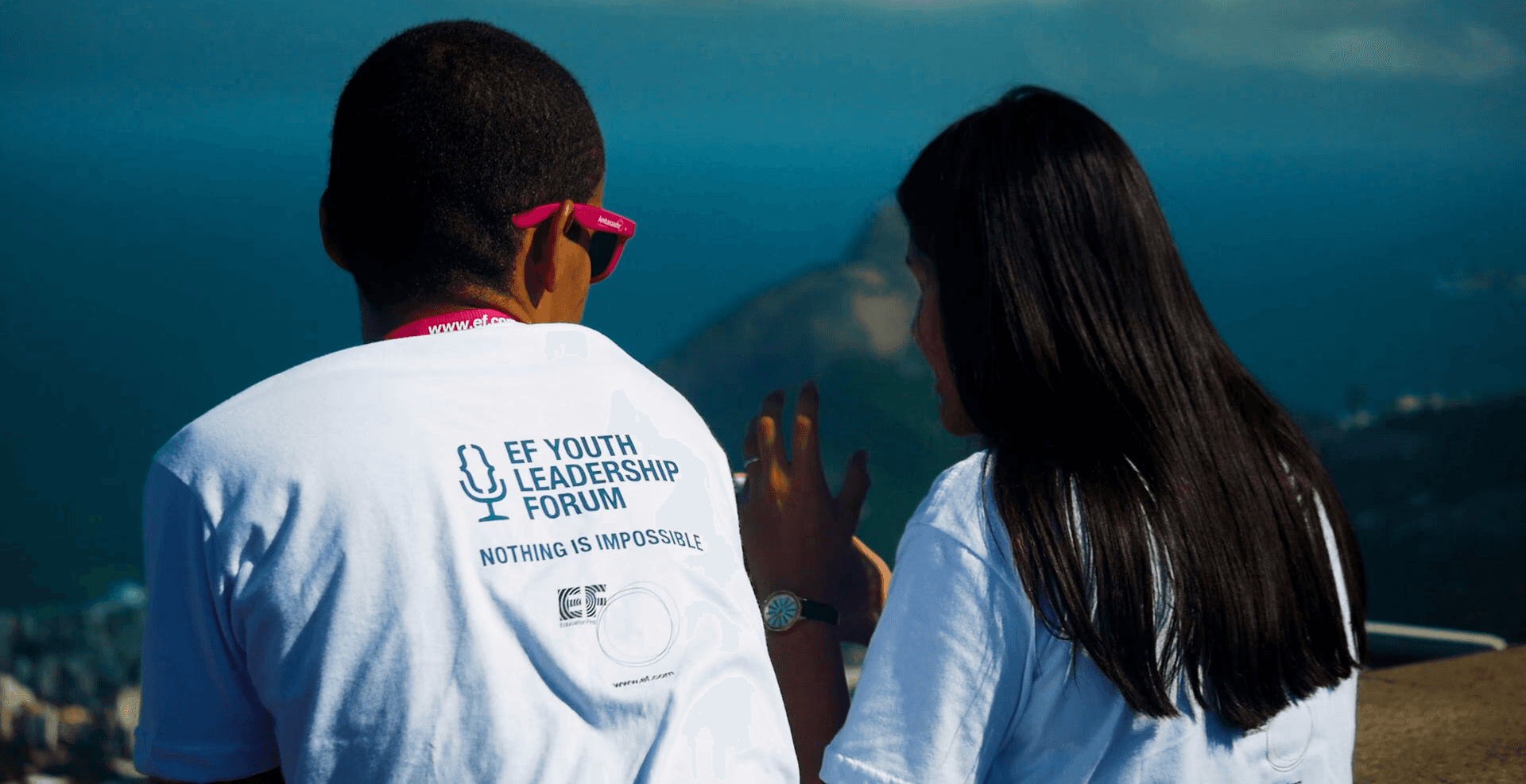 Institutional film frame of two students having a conversation during EF Youth Leadership Forum