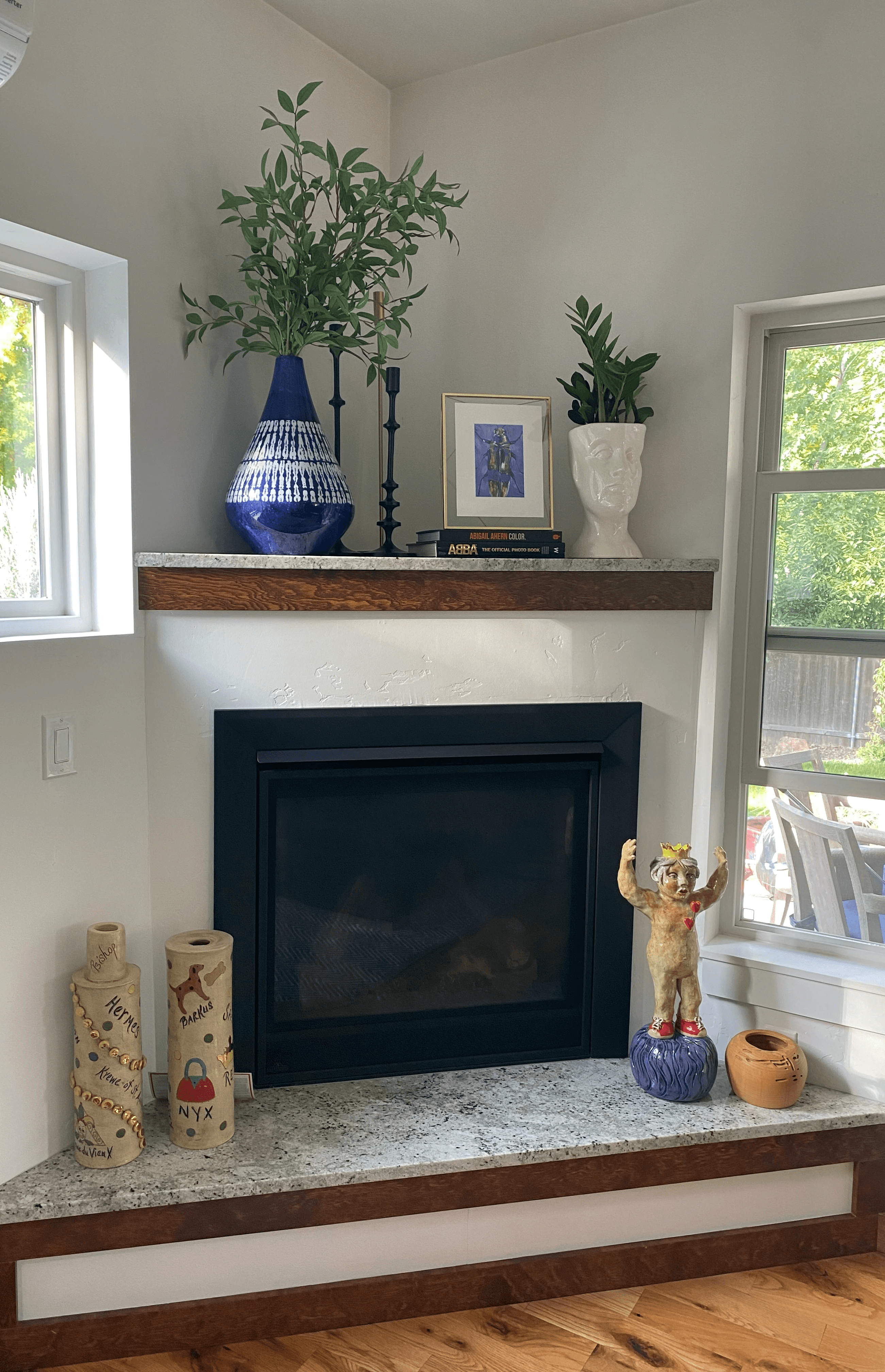 fireplace with blue vase and styled items