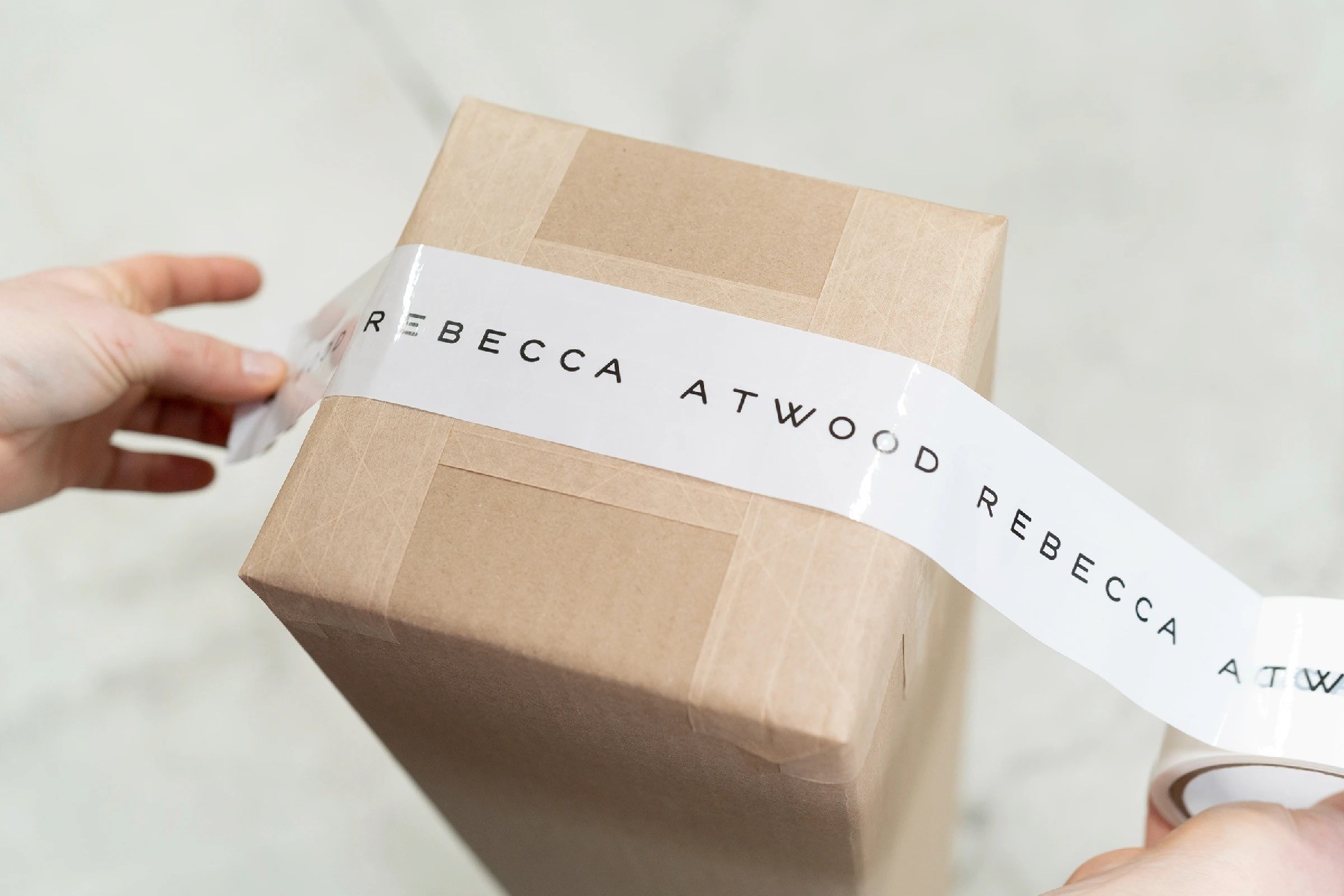 Branded tape being applied to a shipping box.