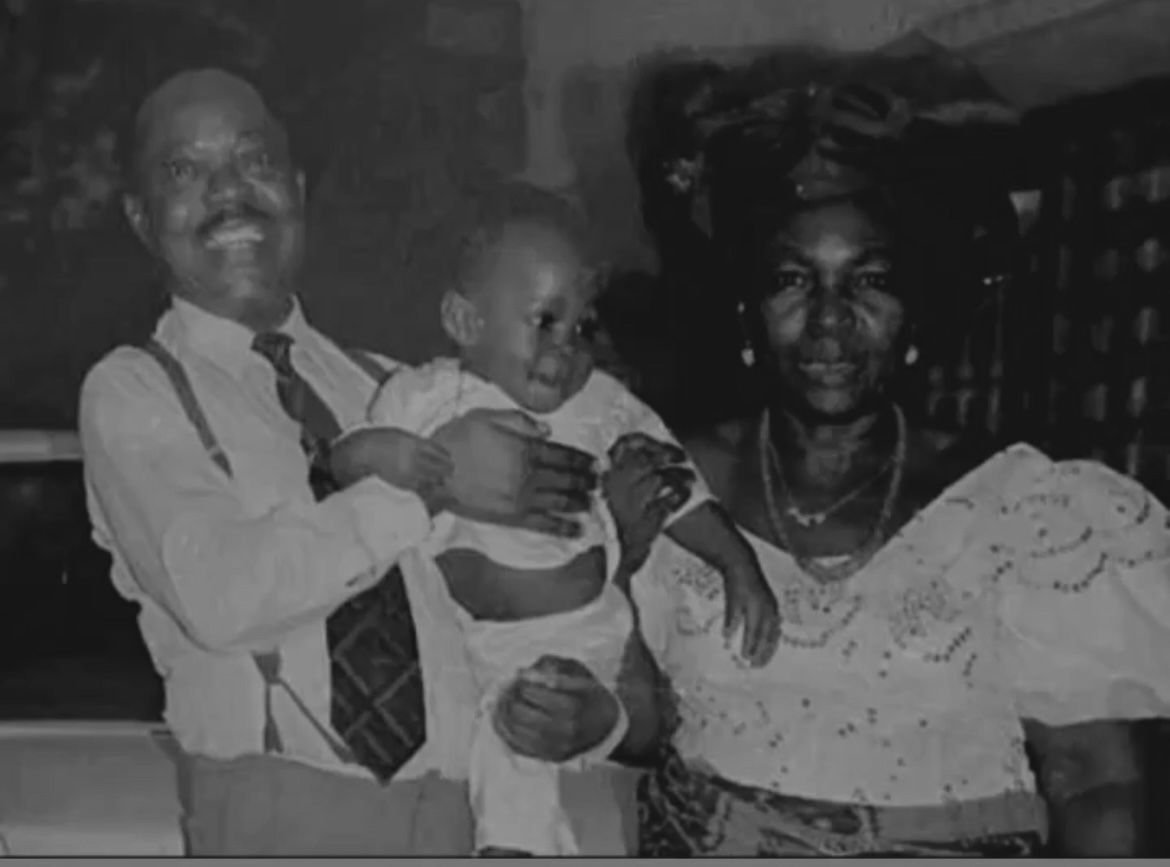 Image of my grandfather and grandmother carrying me 