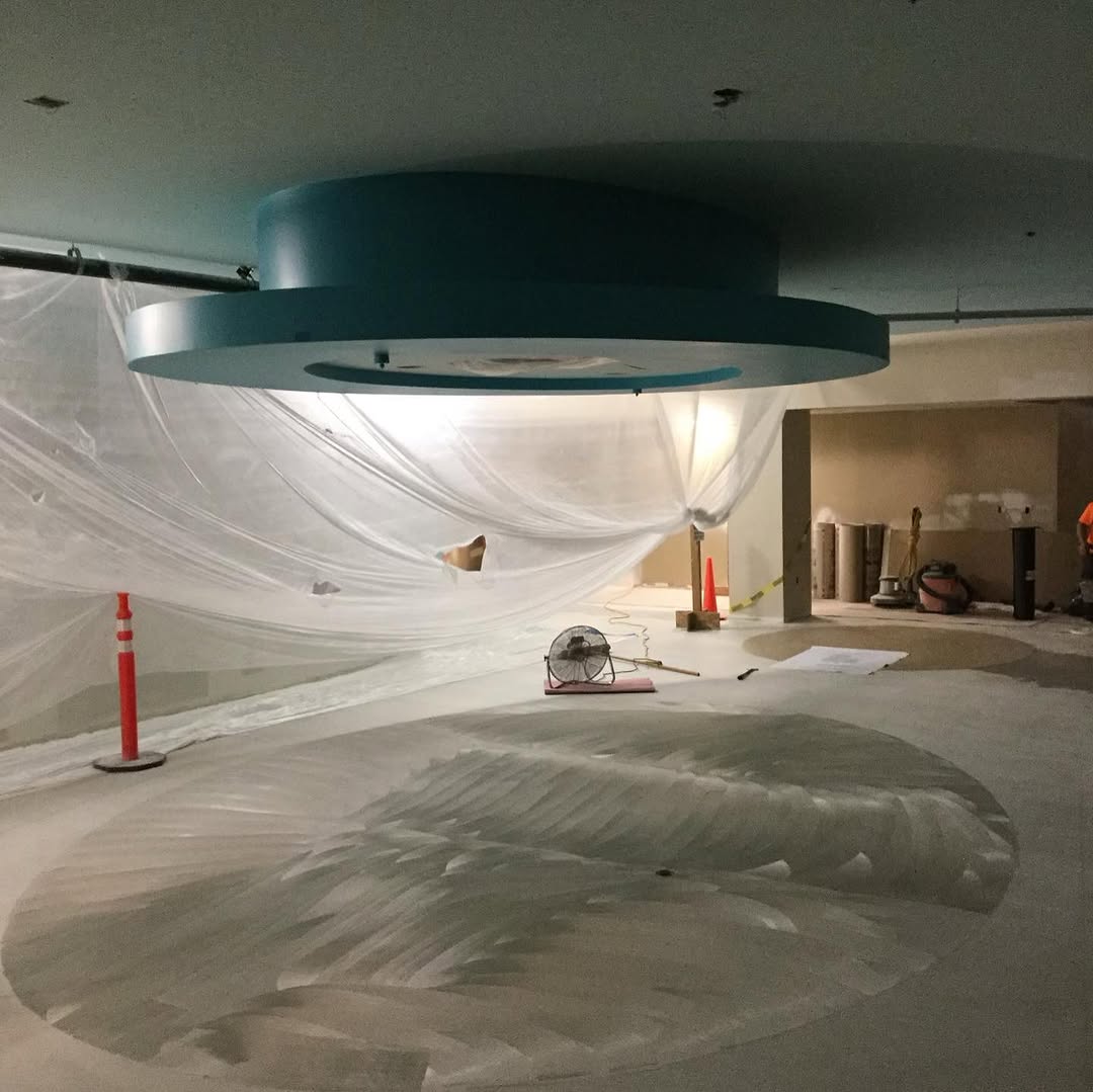 Lobby sealed behind containment sheeting before the new floor goes in