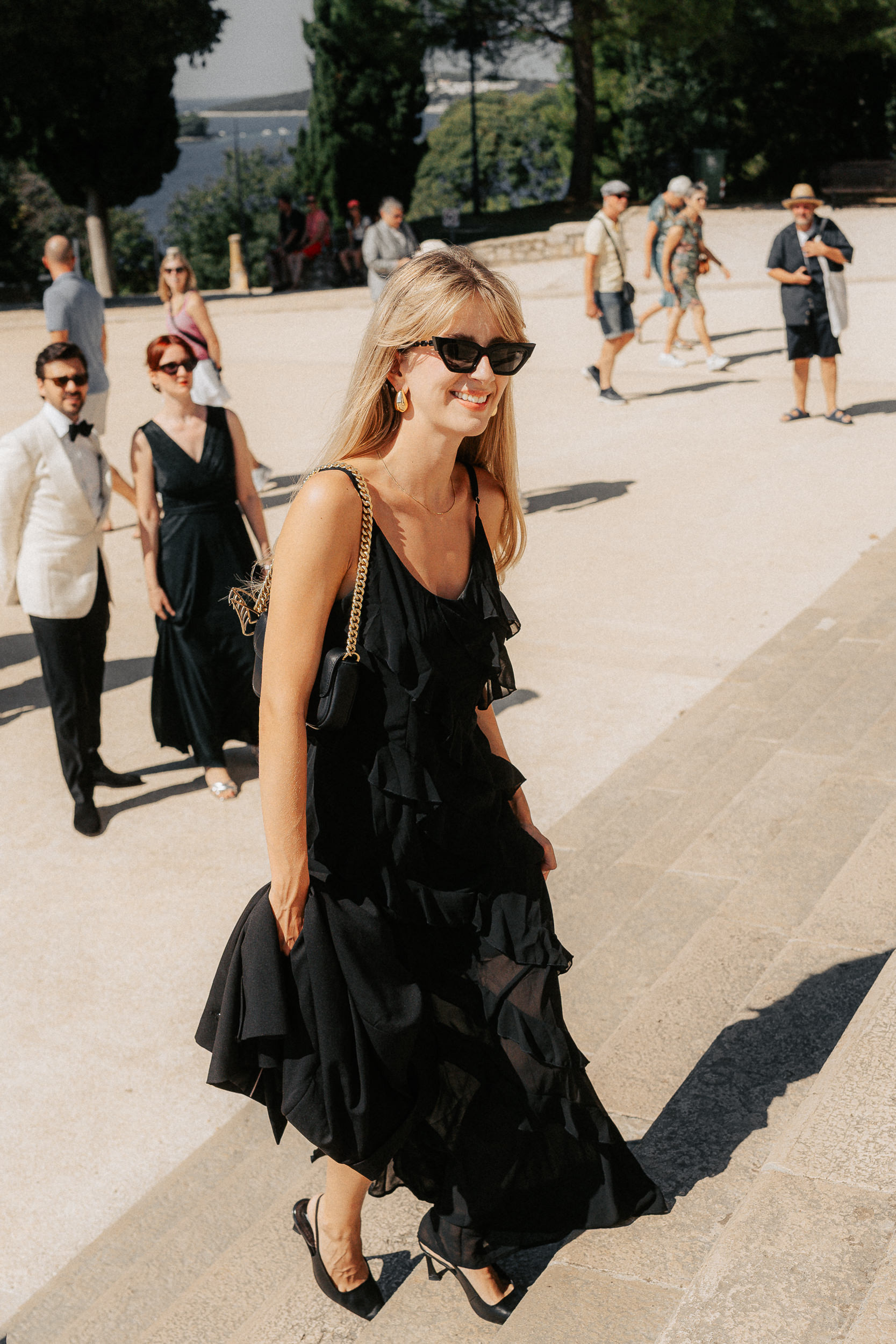 A serene outdoor scene featuring a stone structure adorned with colorful flowers cascading down the steps.
