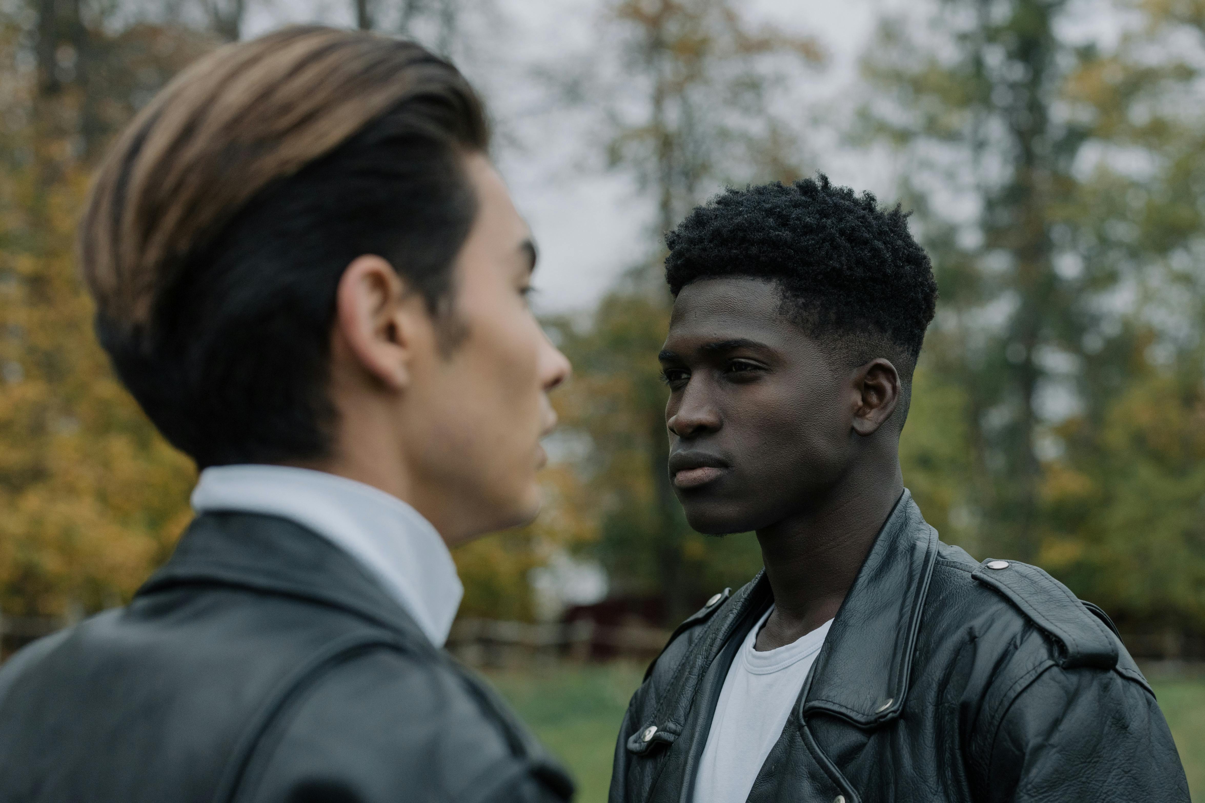 Two women in black suits and headscarves pose.