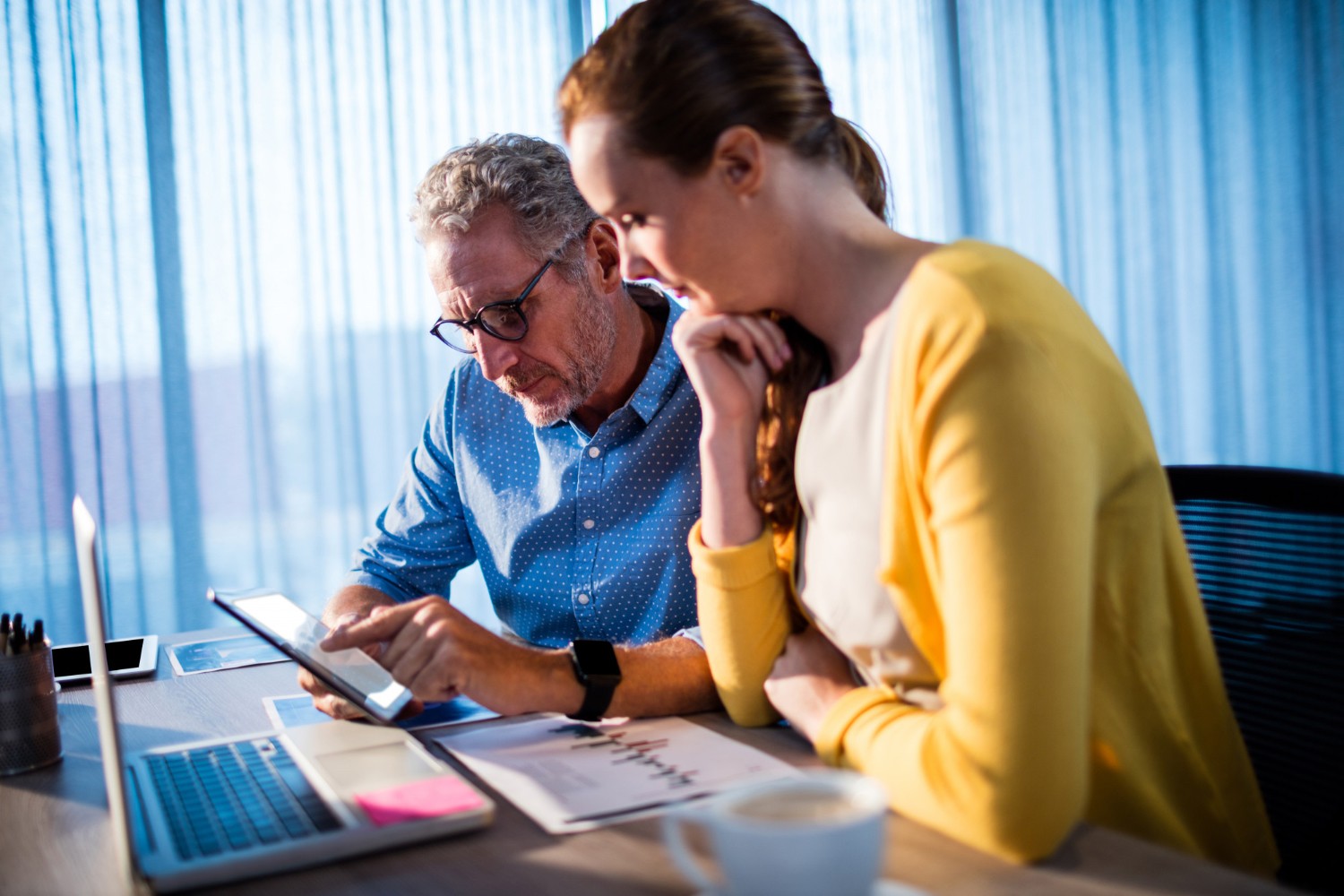 Business leader analysing digital performance charts on a laptop.