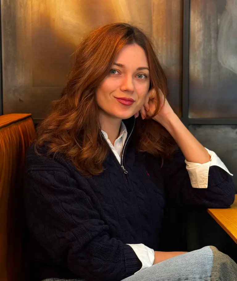A smiling handsome woman in a cafe