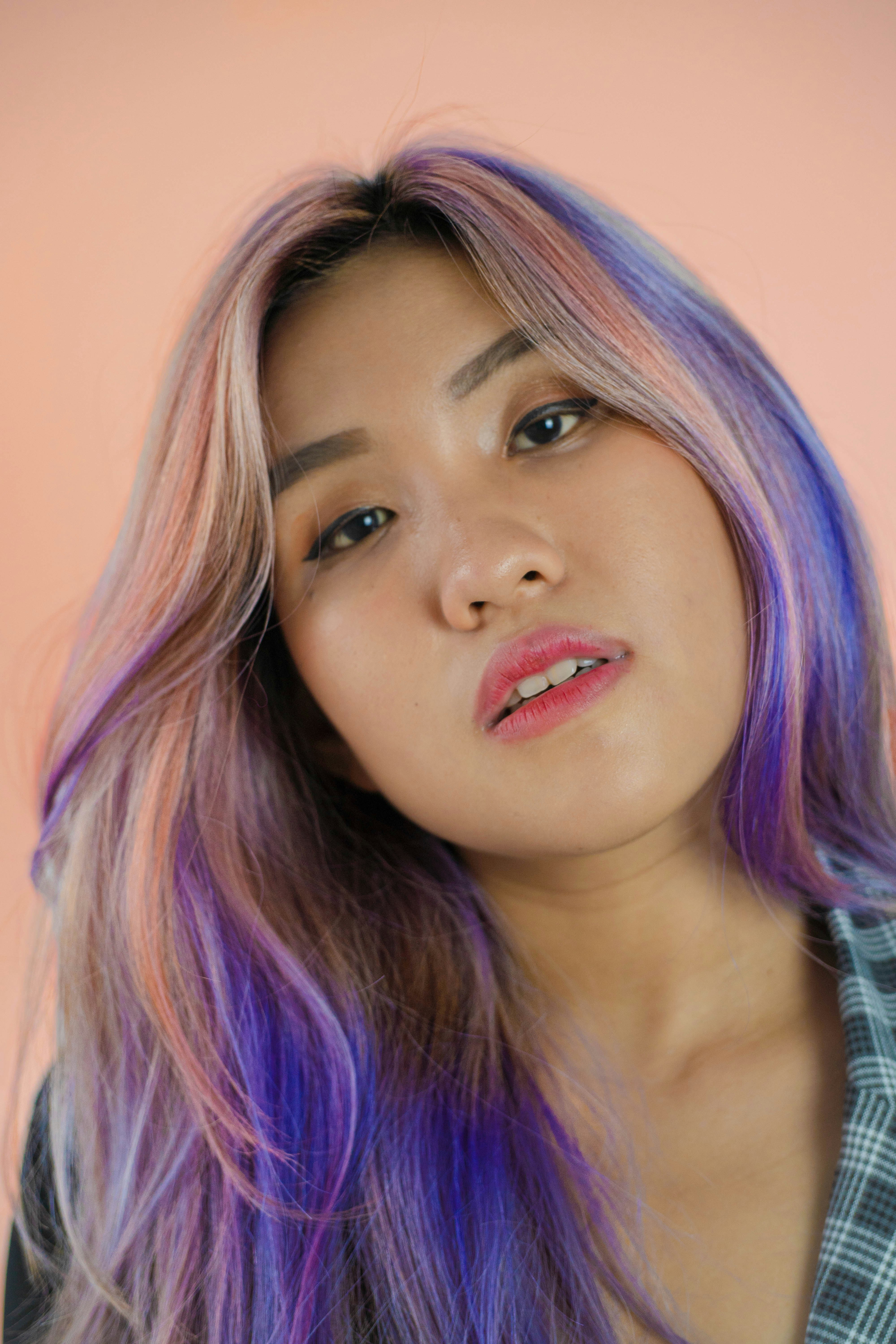 a woman with purple and blue hair posing for a picture