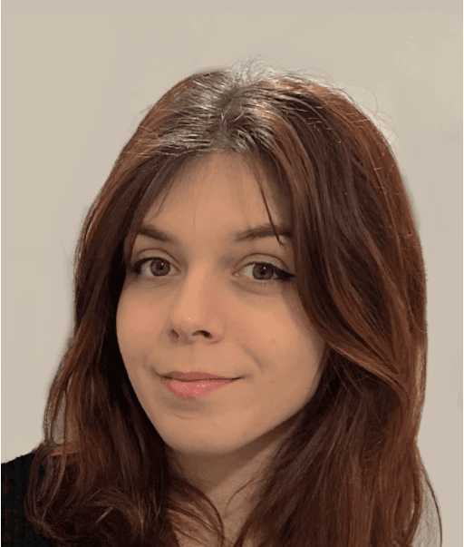 Professional headshot of Giulia Rita Grillo smiling directly at the camera against a plain background.