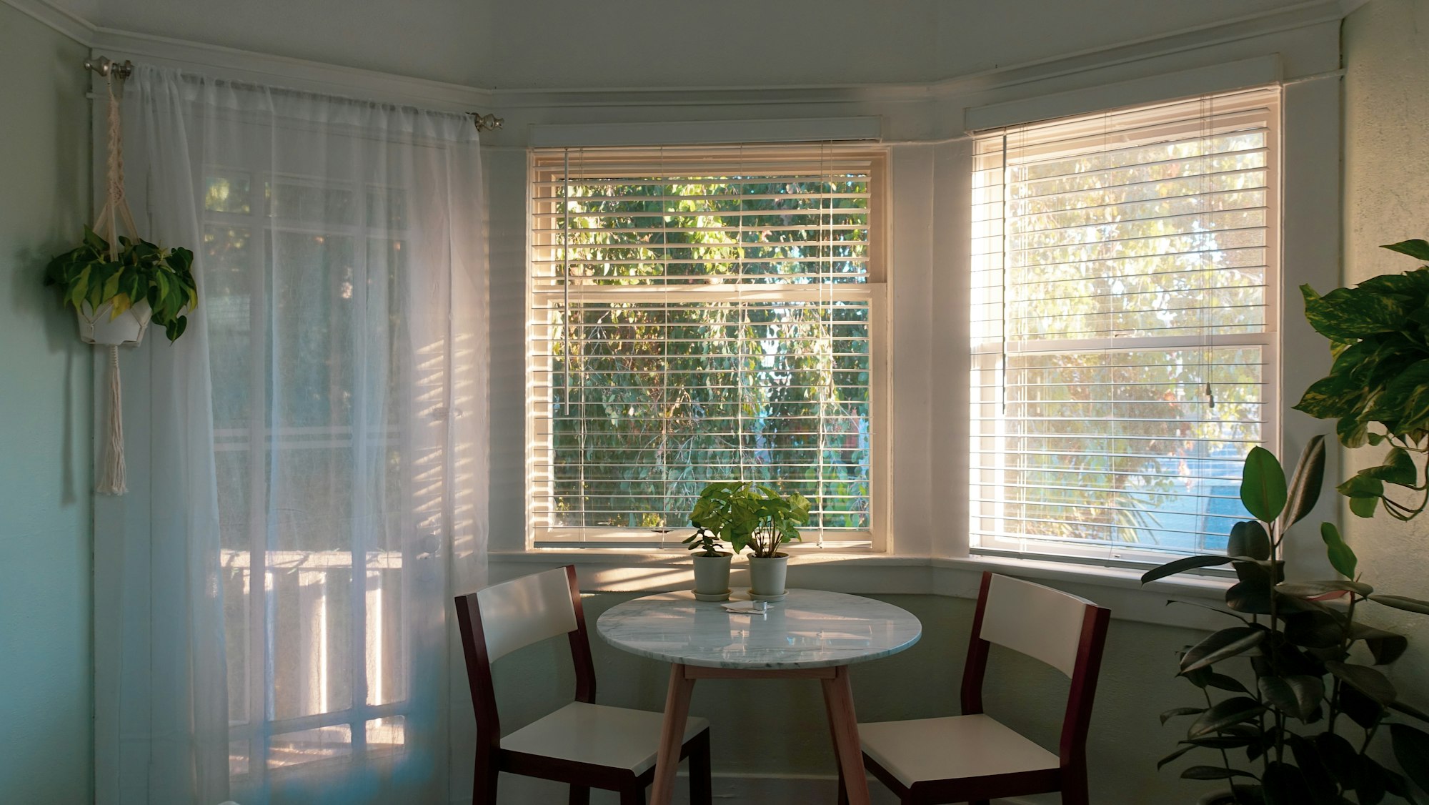 Two chairs at a small table in a bay window