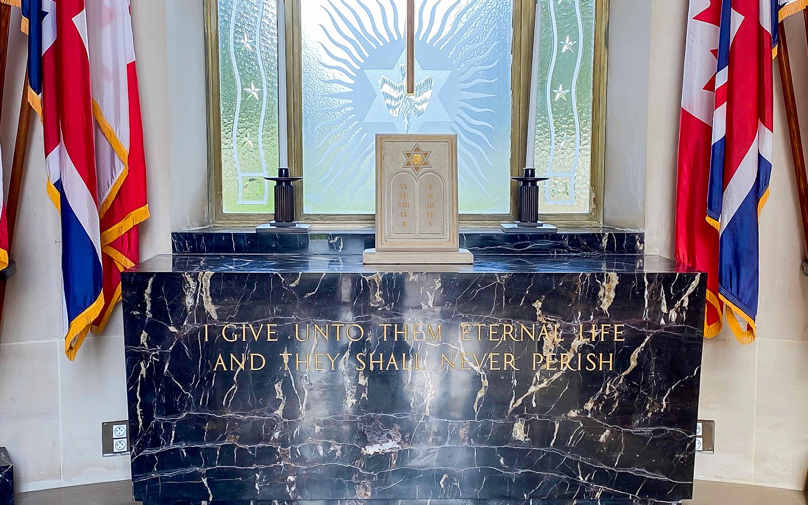 Memorial altar with flags at Normandy American Cemetery, D-Day Normandy Beaches Day Trip.