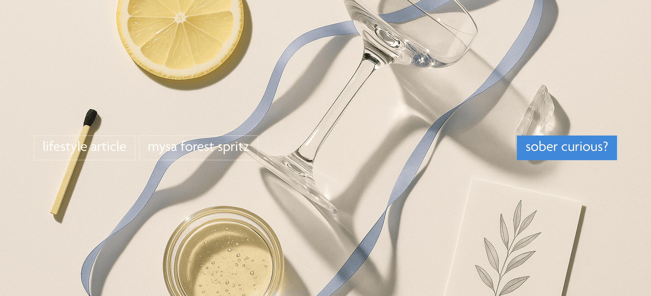 a glass, a lemon, a glass of mysa pale sparkling liquid, a periwinkle blue ribbon