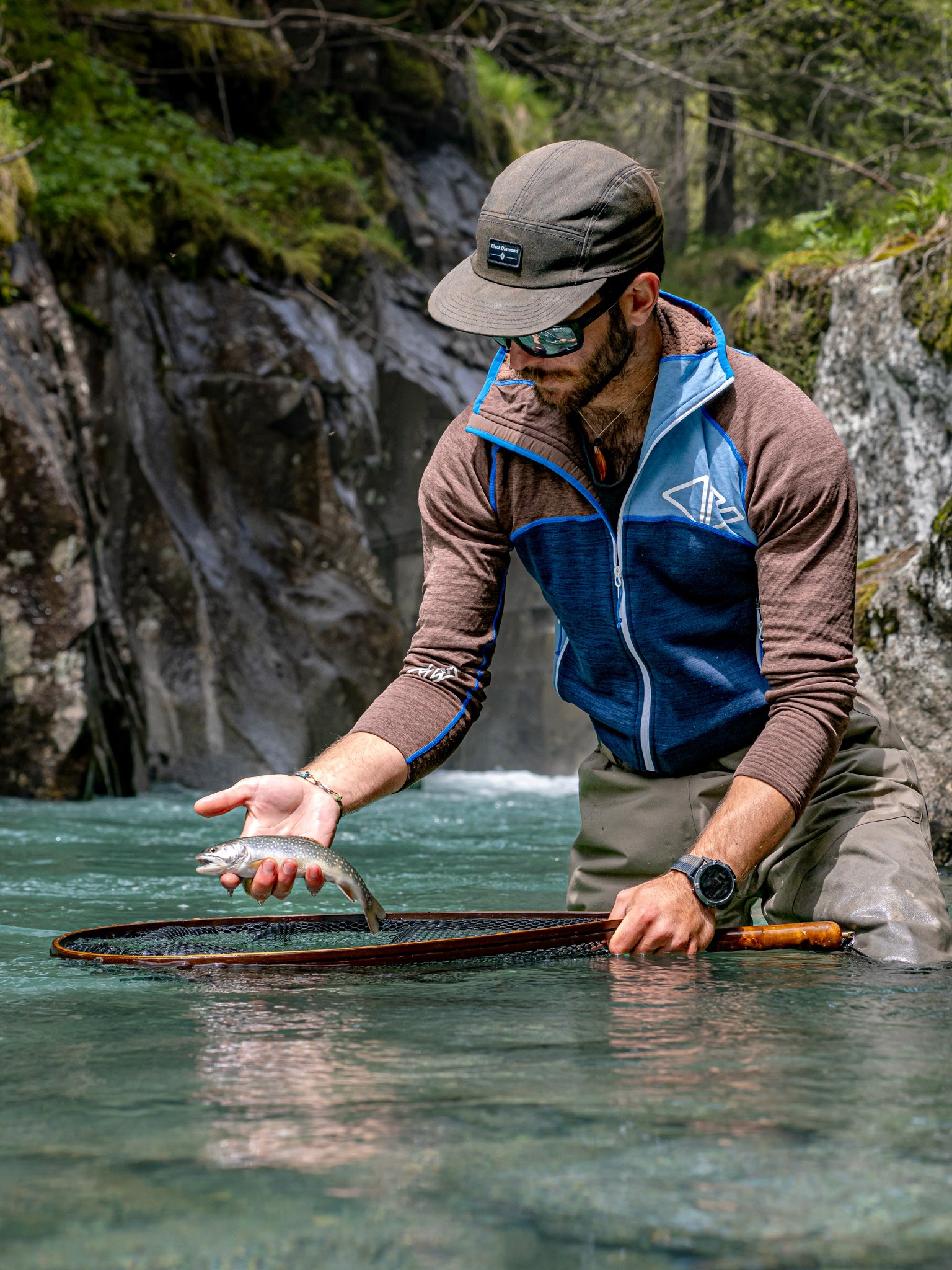 Hiking and fly fishing in Italy's Dolomites, with a guide planning an approach near a stunning riverside trail