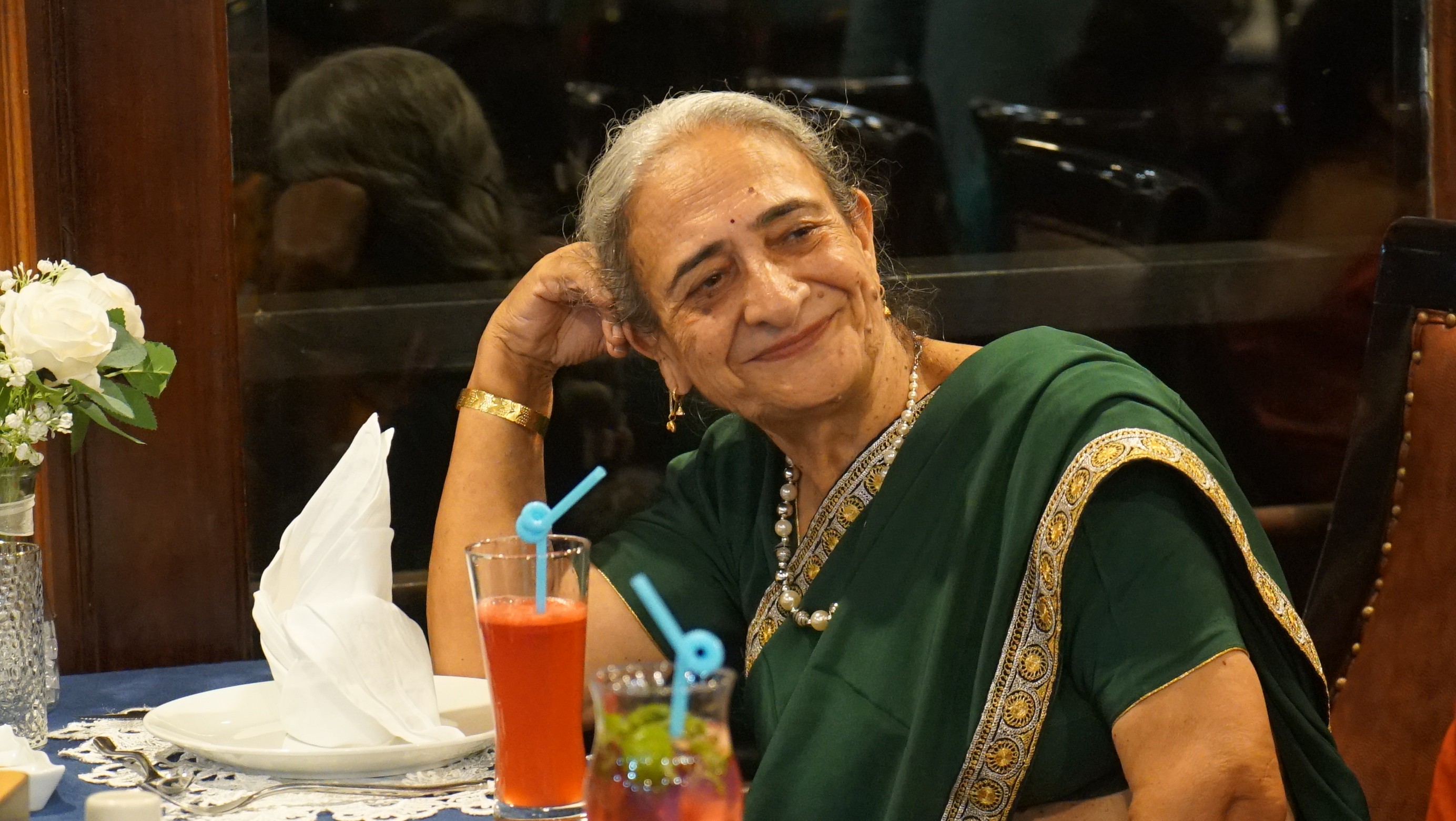 a couple of people standing on top of a mountain