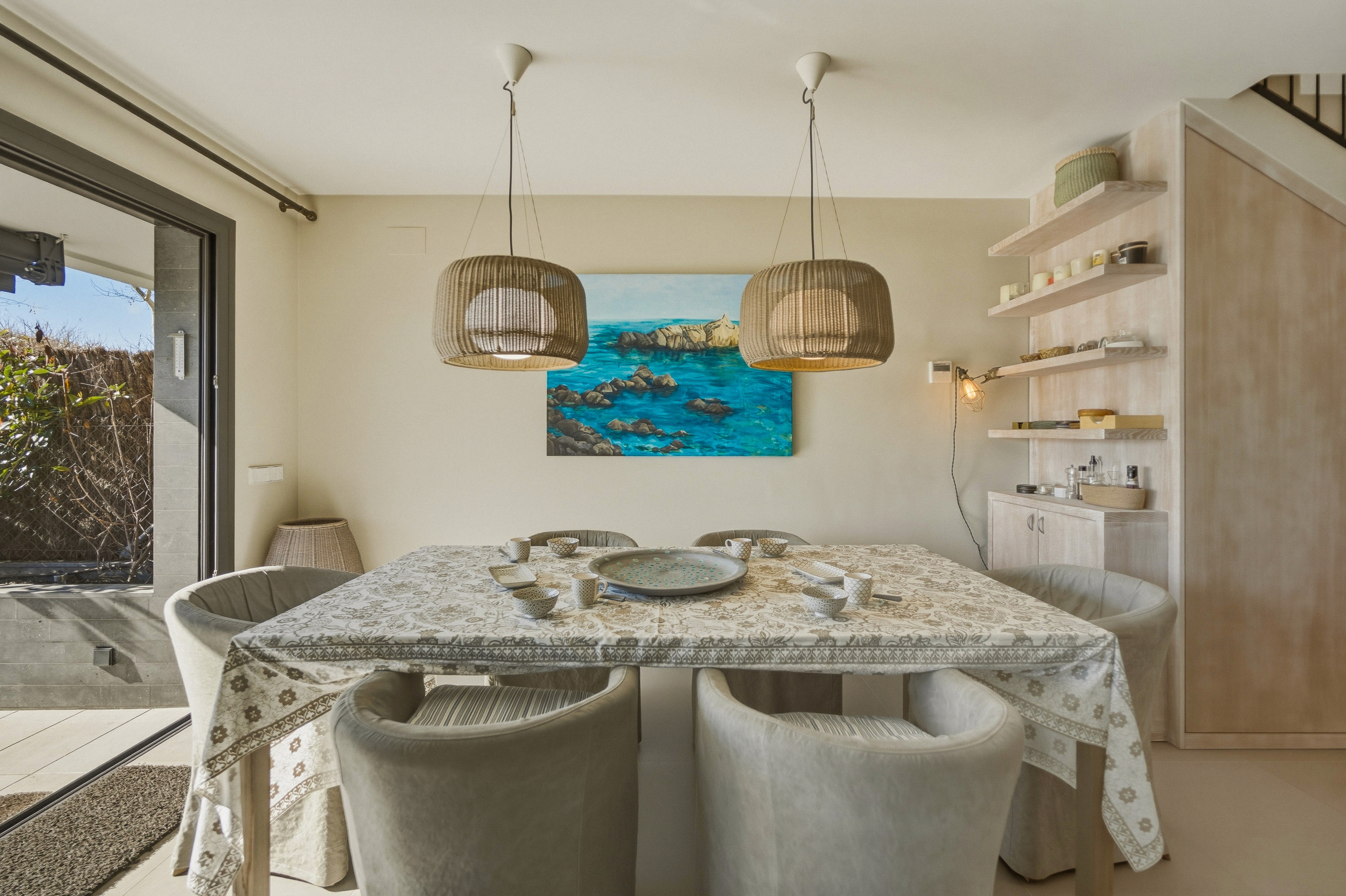 A young woman with freckled skin and long brunette hair lies peacefully in a field of wildflowers, including daisies and poppies, under warm sunlight.