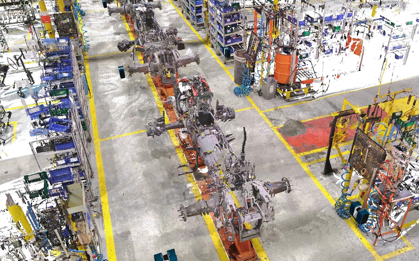 Representação visual de uma nuvem de pontos colorida de uma linha de montagem industrial complexa. A imagem destaca a precisão da Captura da Realidade na documentação de ativos e maquinários, servindo como base para a criação do inventário digital através da solução RAISE.