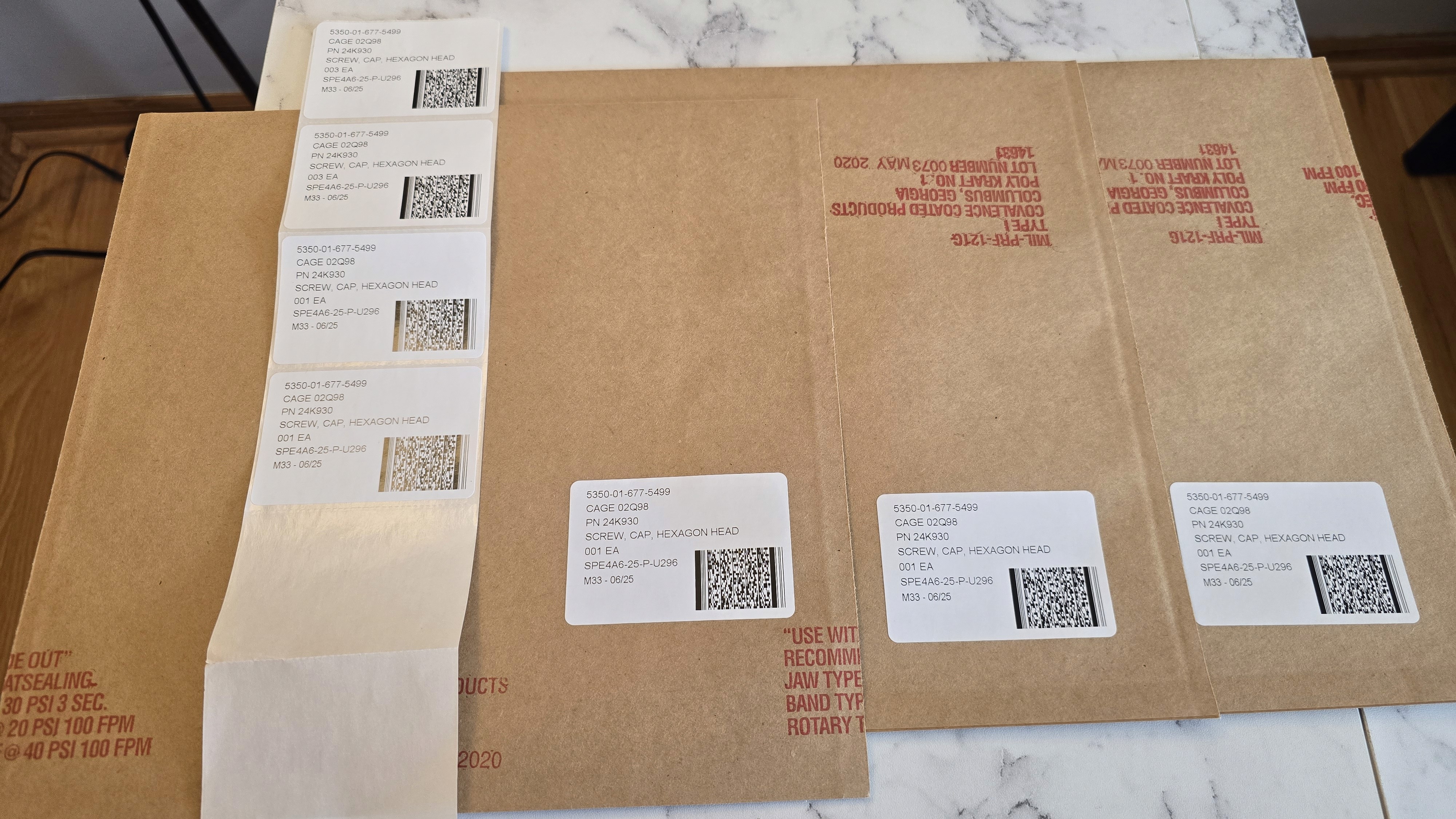 Close-up of a dark green leaf showing its textured surface and central vein against a muted background.