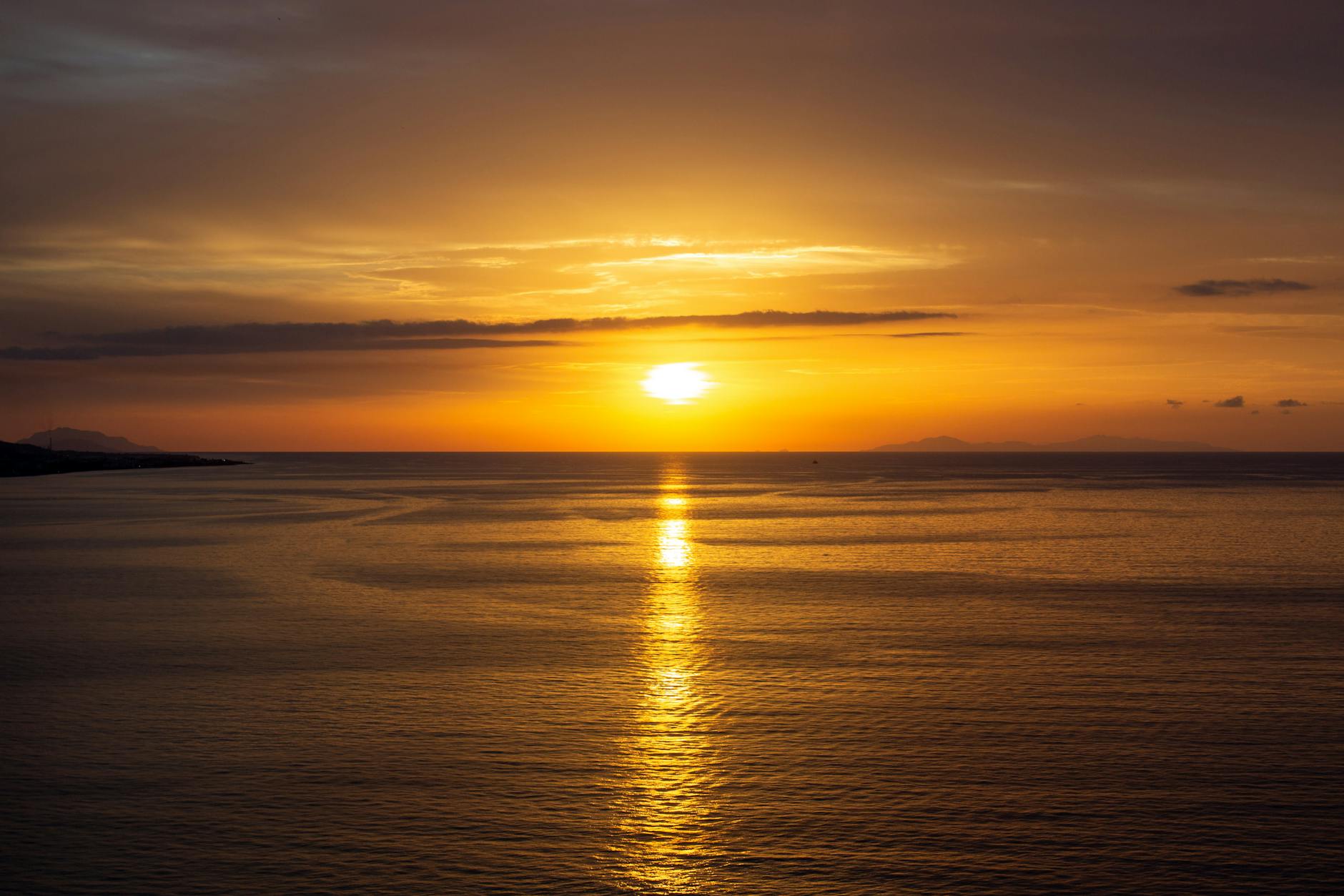 Golden sunset reflecting over a calm ocean