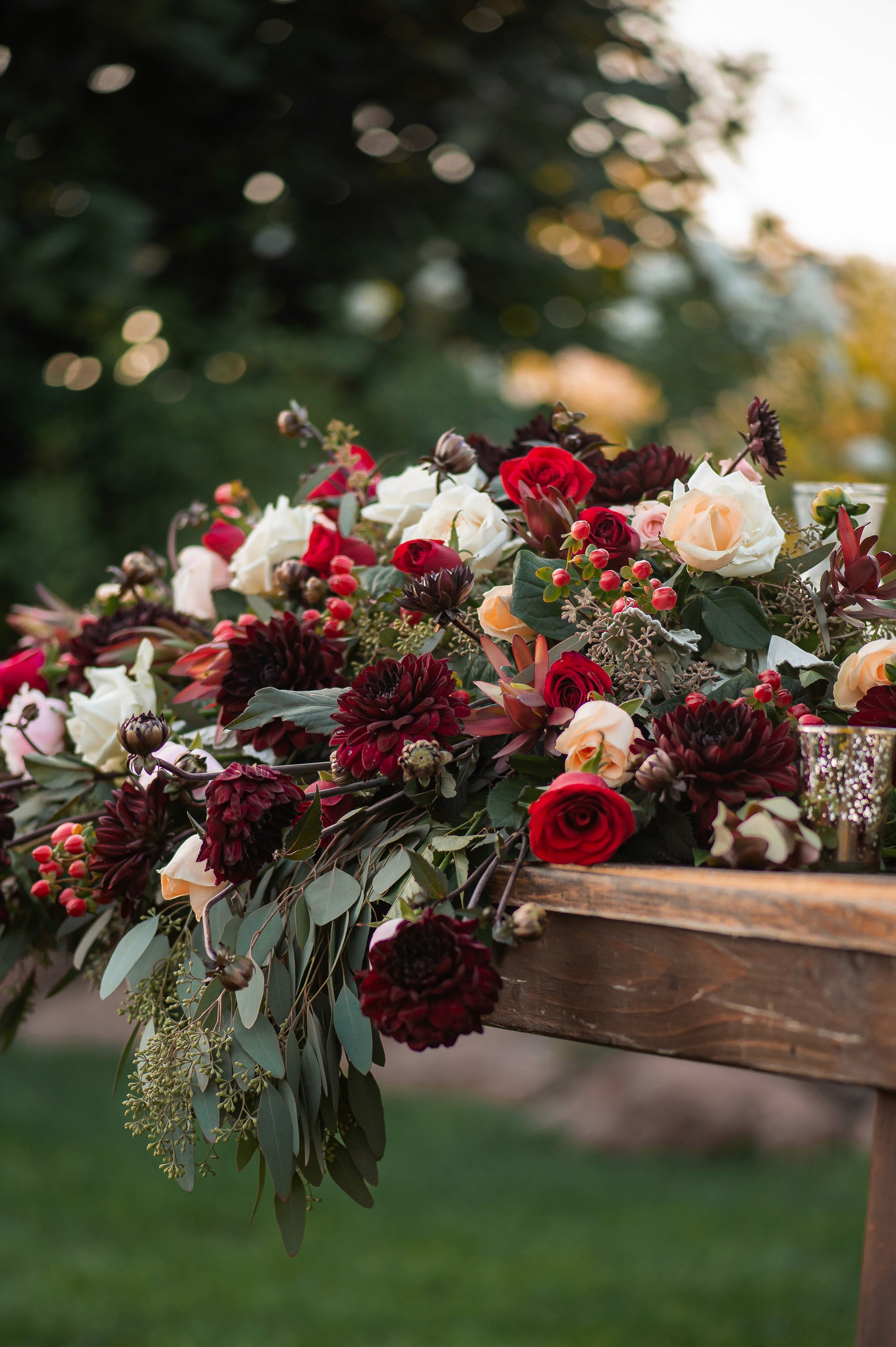 Flat lay wedding details with bouquet, rings, and sparkling bridal heels