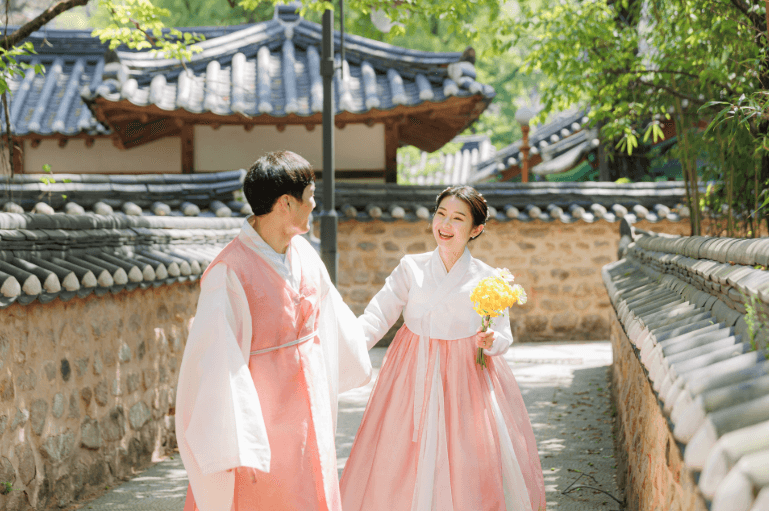 a couple of women walking down a street next to a building