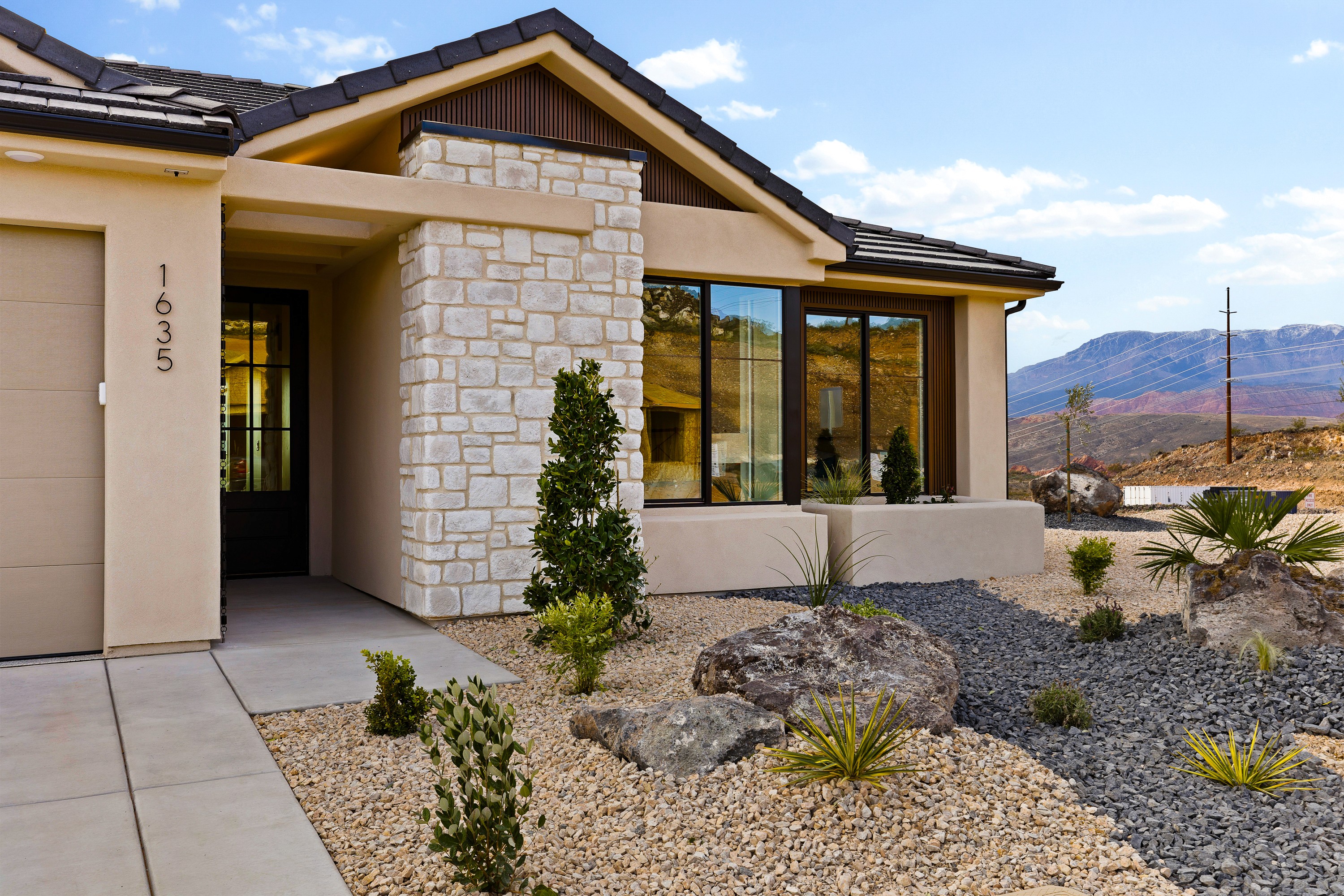 Daytime front exterior of the BYSO House in Hurricane, Utah with clean lines and bright landscaping.