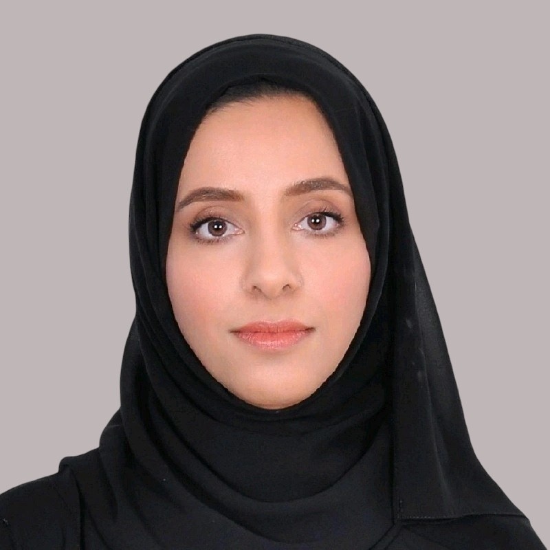 a woman in a black suit and sunglasses