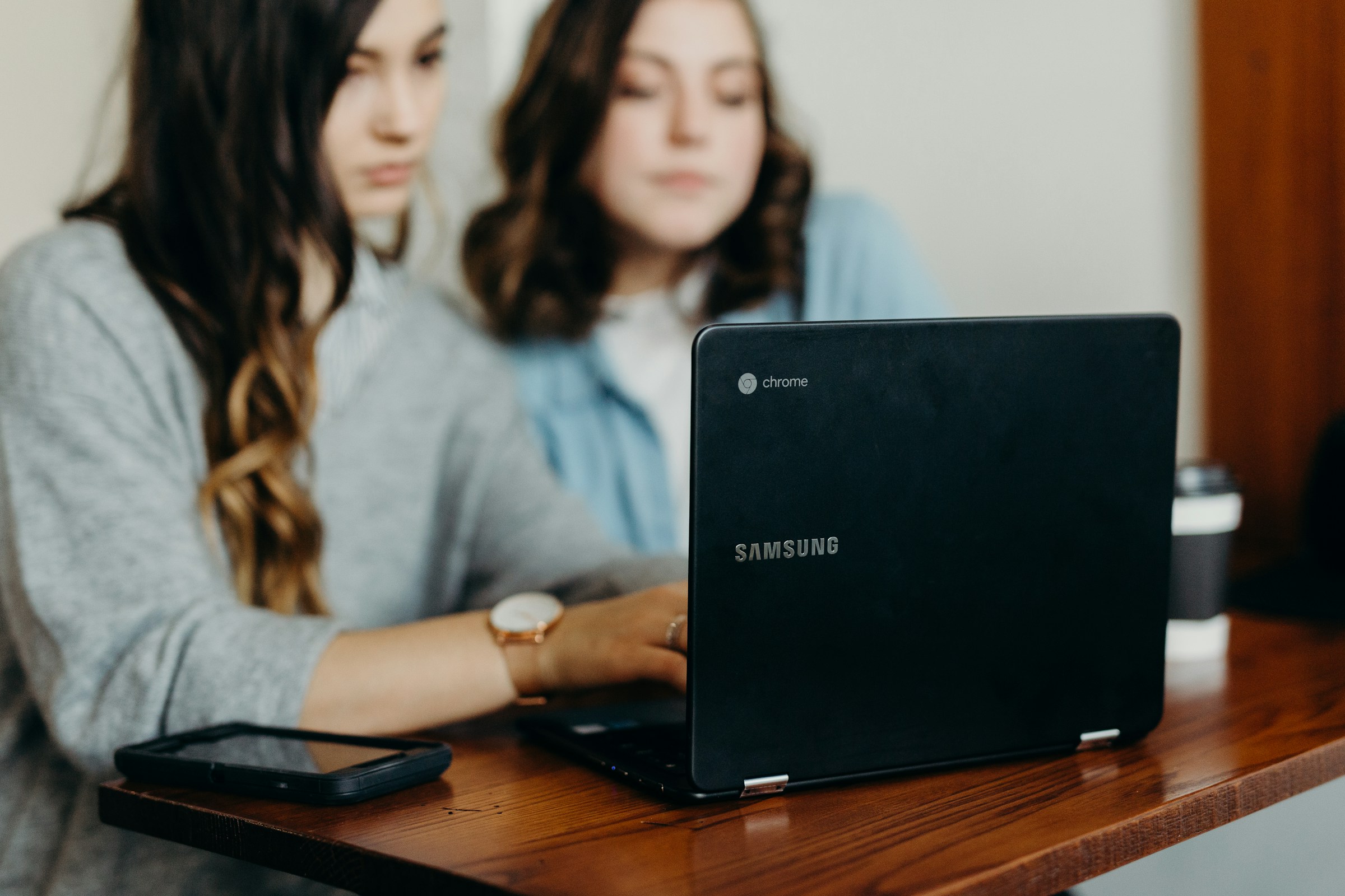 woman typing on laptop - Custom Liquid Shopify