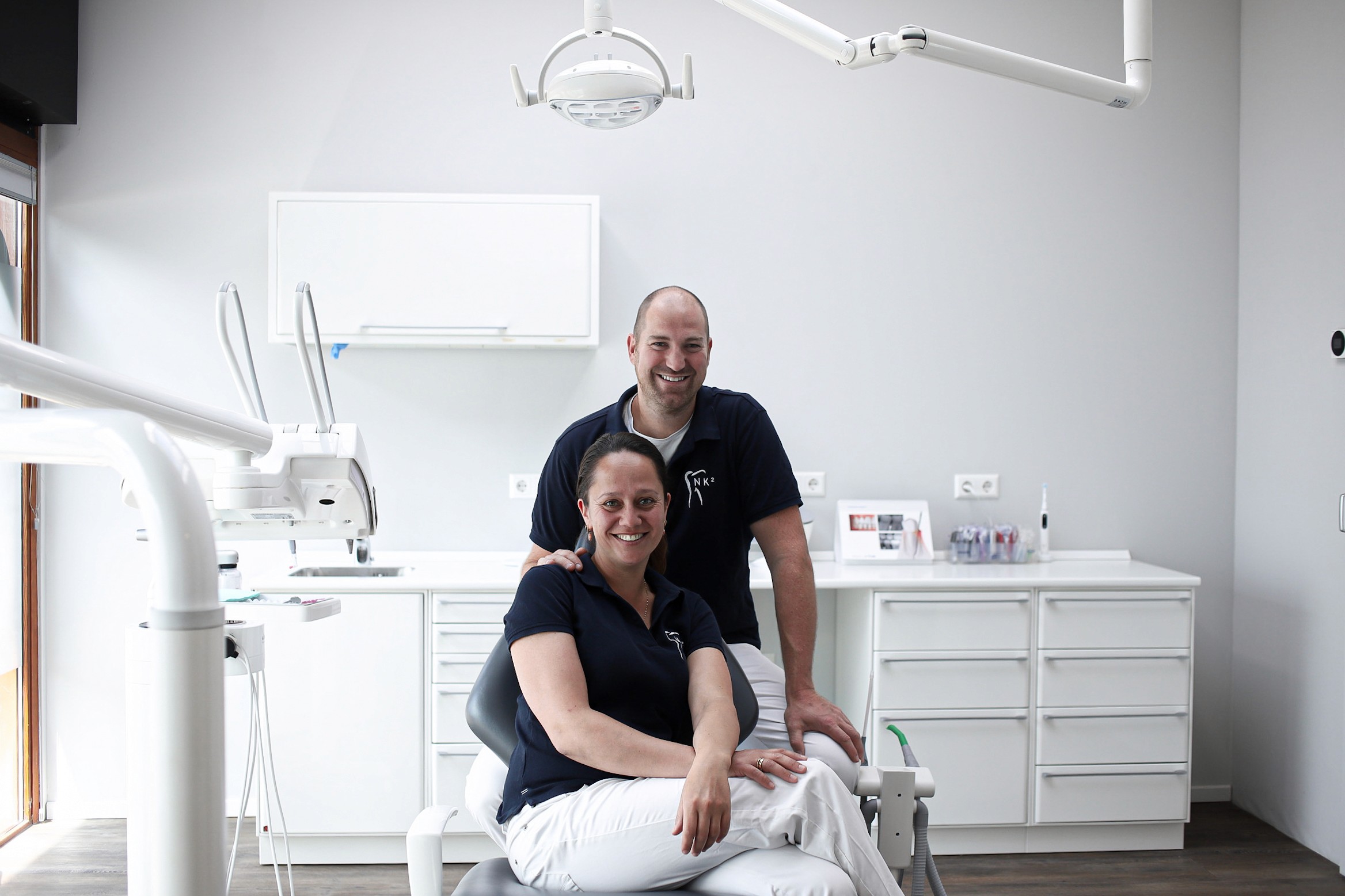 A fast black sports car races down the highway.