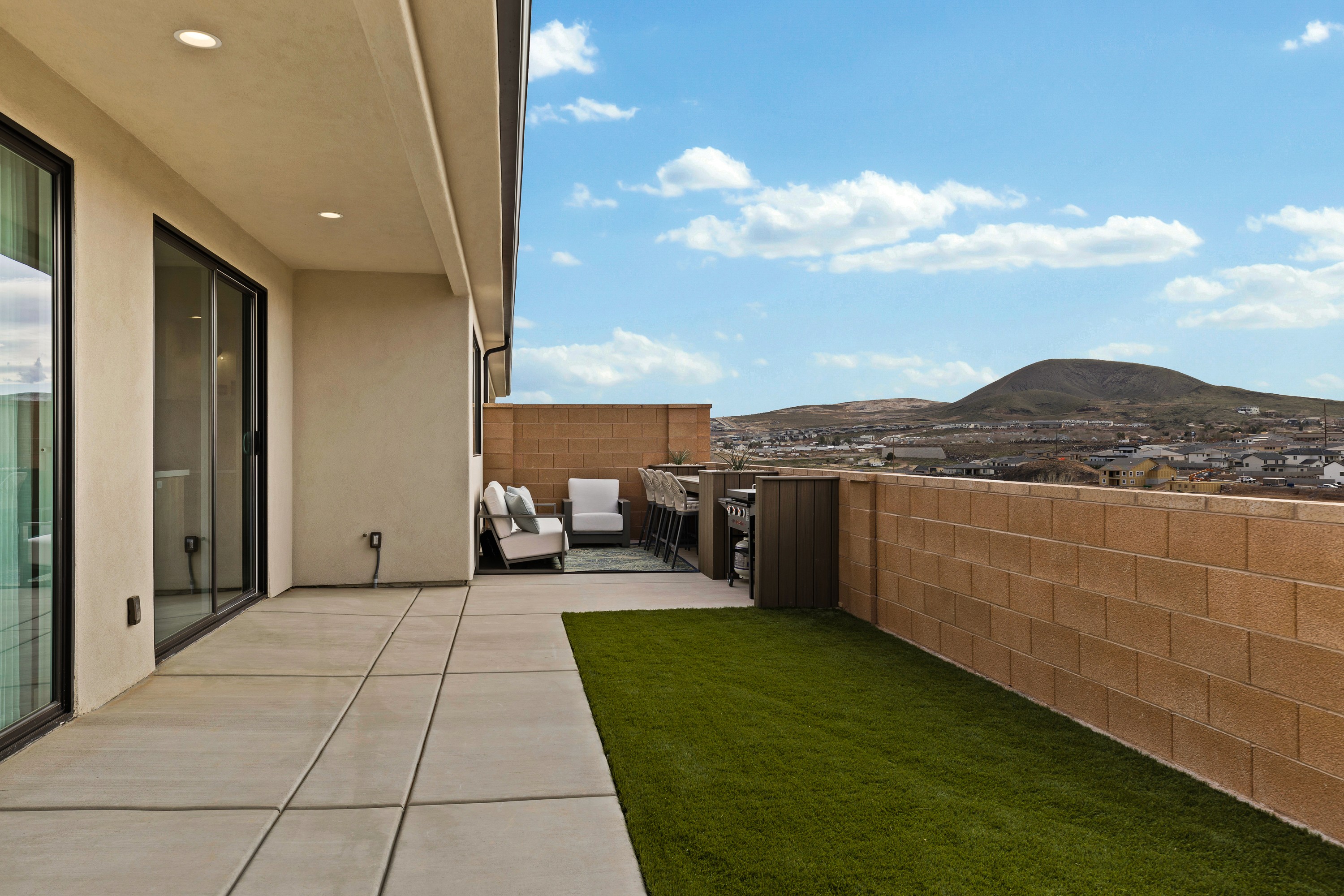 Rear exterior of the BYSO House in Hurricane, Utah with patio and backyard space.