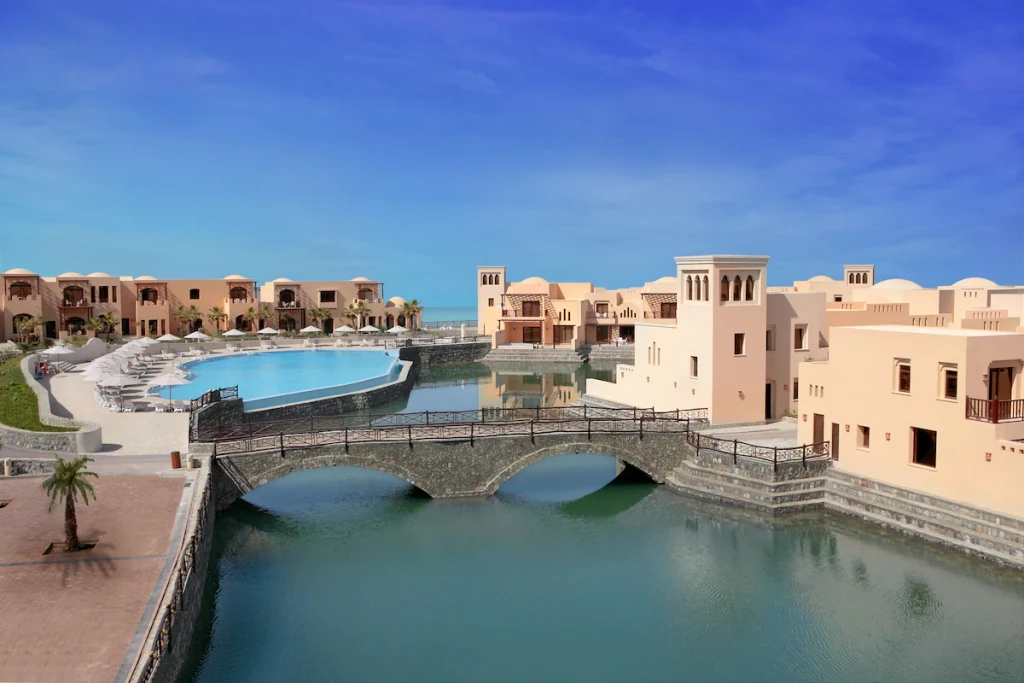 The Cove Rotana transportation area featuring shuttles and vehicles for guest convenience in a scenic resort setting.