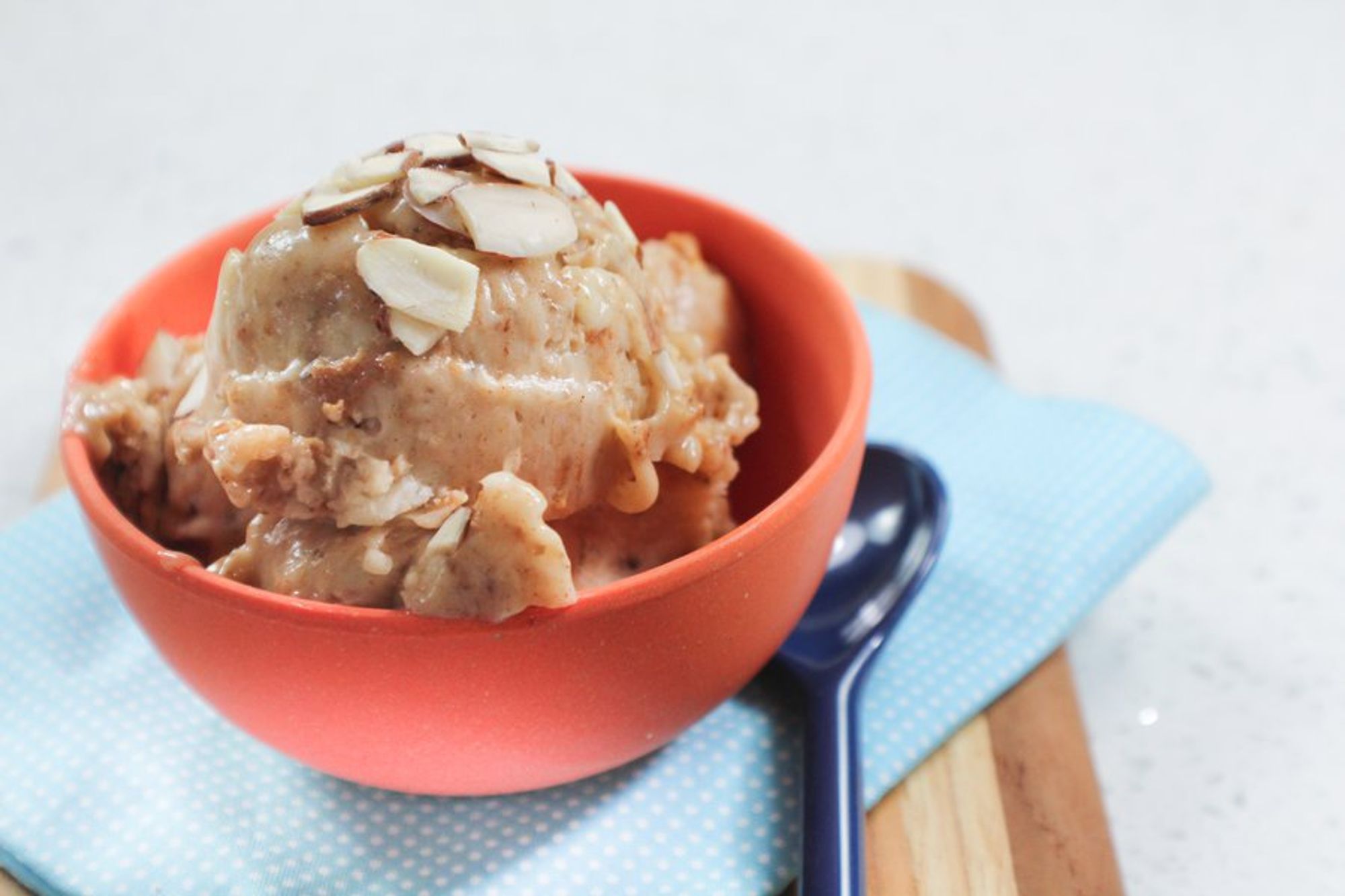 banana ice cream with almond butter served in a small bowl