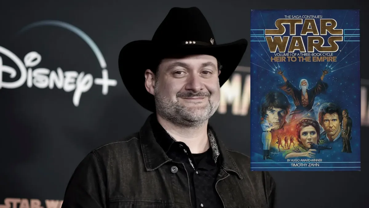 Dave Filoni in a black cowboy hate in front of a Mandalorian sign with a copy of Heir to the Empire next to him