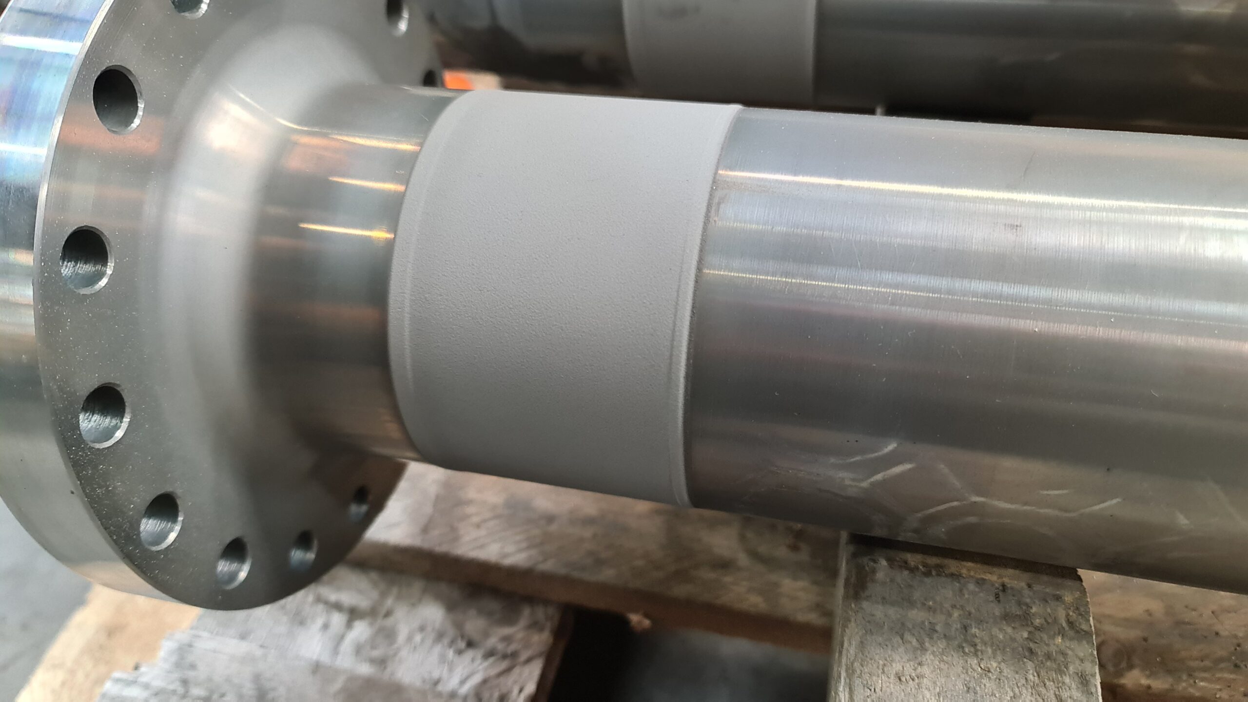 Thermisch gespoten coating aangebracht op een flensas bij Plasma Service