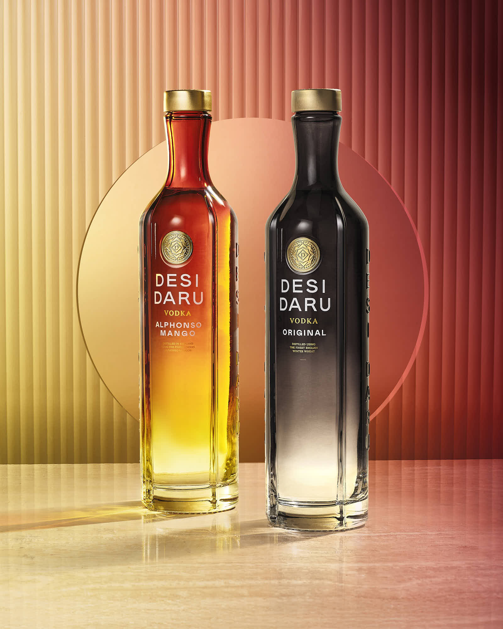 Two elegantly designed bottles side by side, one orange and the other black, set against a gradient background.