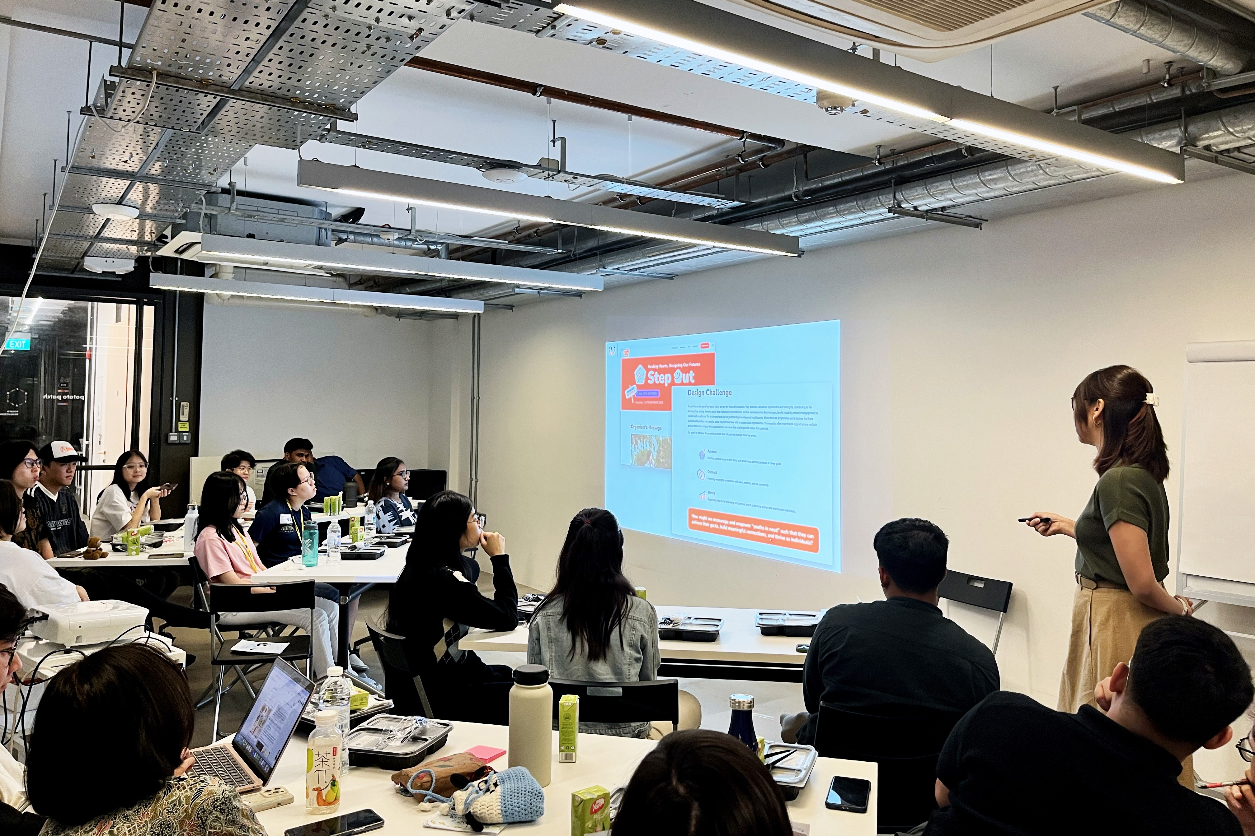 Workshop participants attentively listening to a presentation on Designing a Problem Statement