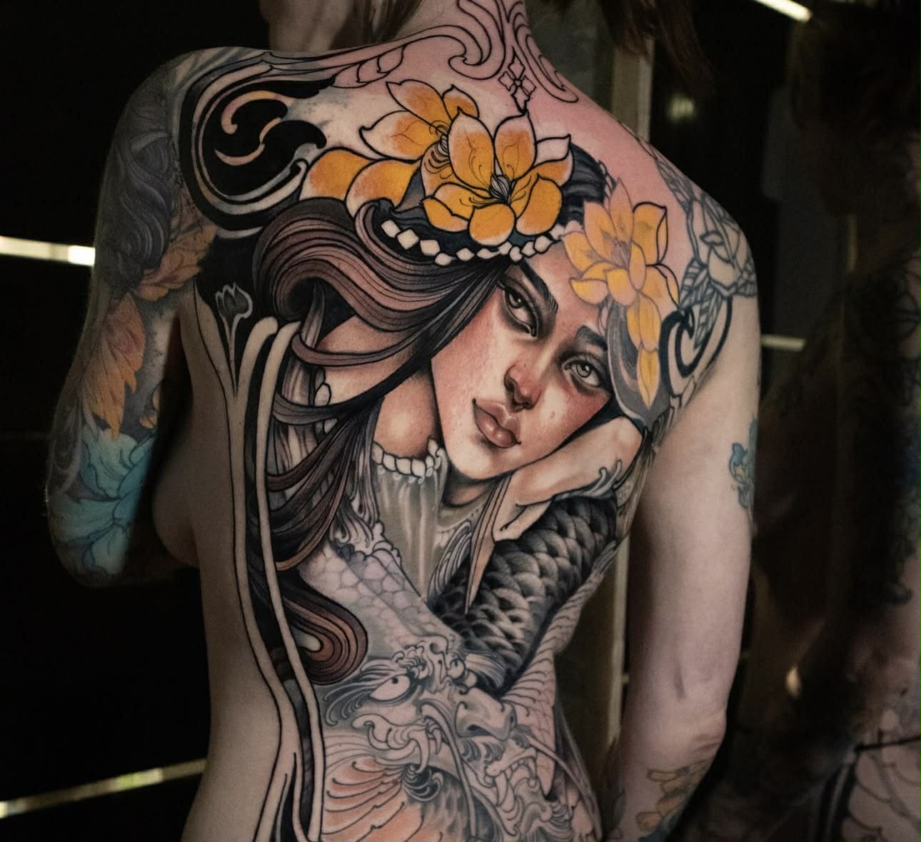 Leg tattoo with celestial and geometric patterns.