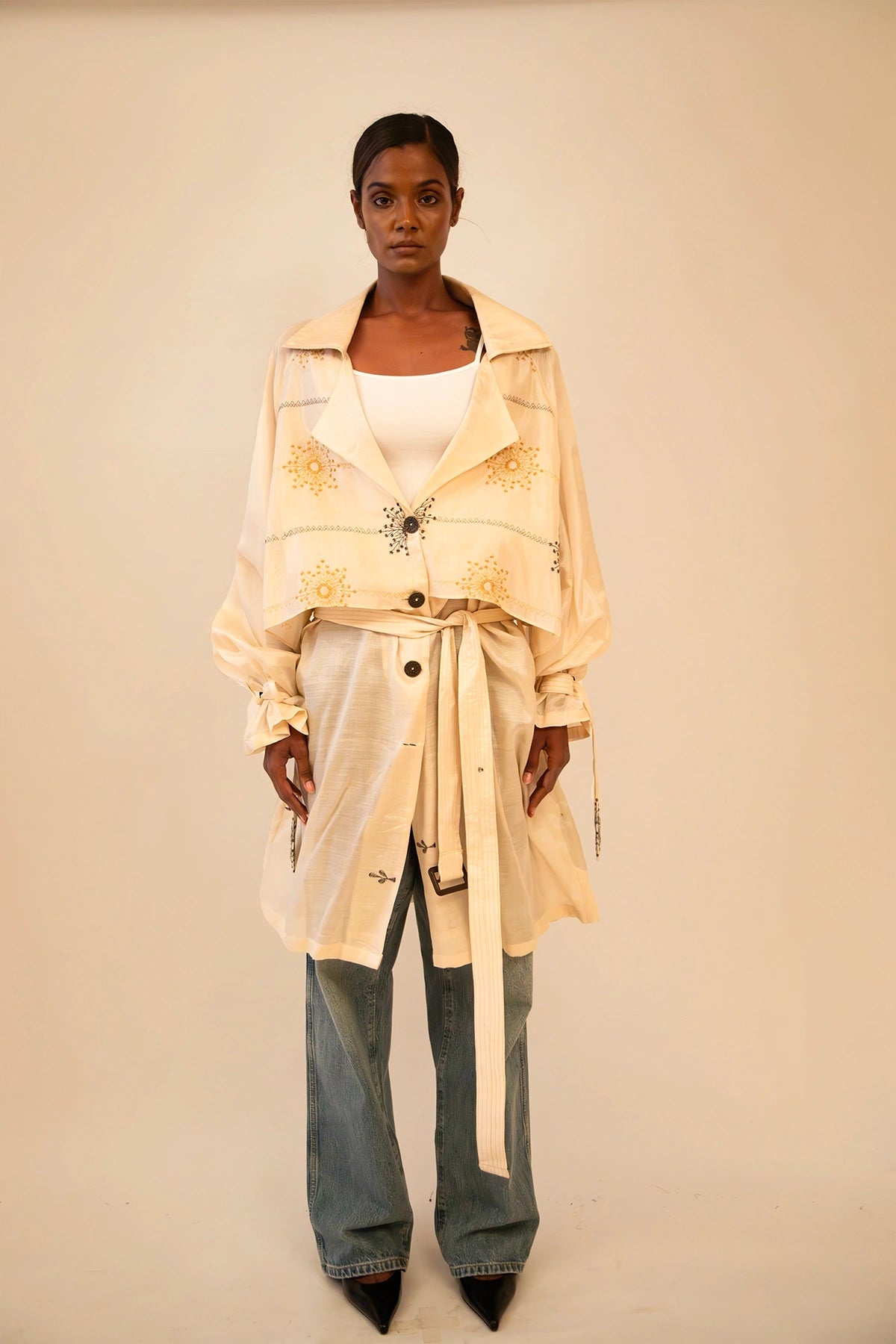 Off-white vintage trench coat without lining, featuring a relaxed fit and lightweight drape, ideal for layering and conscious styling.